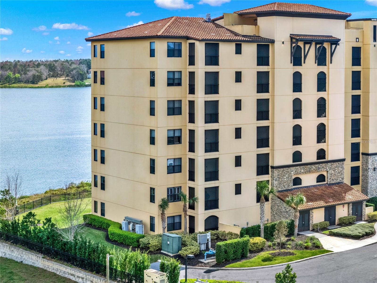 NOW SELLING THIS GORGEOUS CONDO FULLY FURNISHED WITH OVER $50k OF HIGH-END FURNISHING FROM RESTORATION HARDWARE! This stunning 3-bedroom, 3-bath corner unit condo in the prestigious Siena at Bella Collina offers breathtaking views of Lake Siena from nearly every room. Situated in a gated community, this unit boasts an open floor plan that seamlessly integrates the gourmet kitchen, family room, and dining area, all showcasing panoramic lake views.
The chef’s kitchen features sleek espresso cabinets, stainless steel appliances, tiled backsplash, new convection double oven with Wi-Fi, and custom storage solutions. Enjoy your morning coffee from the screened-in tiled balcony, perfect for relaxing and taking in the scenery. Additional upgrades throughout the home include all-tile flooring, plantation shutters, crown molding, custom curtains and blinds, new fans and lights throughout, a reverse osmosis filter system and an upgraded heating system.
Owners enjoy the luxury of two assigned parking spots, a gated community and nighttime security. The community offers resort-style amenities, including a heated pool, walking trail around the lake, firepit, BBQ area, poolside seating, conference room and a 24-hour fitness center. For socializing and dining, owners have access to two on-site restaurants and can participate in year-round culinary and social events at The Club at Bella Collina.
This condo truly exemplifies luxury living with a prime location and exceptional features, offering the best of both privacy and convenience. Ask your agent for the list of furniture that comes with this property! Welcome Home!