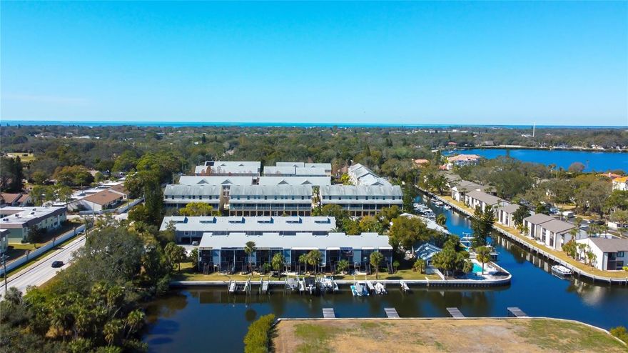 Discover a one-of-a-kind 4-Story WATERFRONT TOWNHOME with DEEDED BOAT SLIP, offering the perfect retreat to call home!   This charming property with high ceilings and plenty of natural sunlight, is complemented with attractive flooring throughout each floor.  The main living area is open and spacious with sliders leading to a private covered balcony offering a quiet space to relax and unwind overlooking the canal.  As you head upstairs to the 2nd floor, you’ll find a guest bedroom, full bath and convenient laundry closet designed for a stackable washer/dryer.  The 3rd floor encompasses the primary bedroom with ensuite bath, walk-in closet and another covered balcony to savor unforgettable sunsets!    On the 4th floor, you’ll find a versatile loft, ideal for a reading area, play area or add a bed for guests!   There’s ample storage throughout the property, including 2 storage closets on both balconies and large cabinets above the carport.  The lower level features a unique patio lounge for peaceful outdoor relaxation and storage for water toys!  Your personal boat dock is only steps away, making it easy to hop on your boat for a day of sunshine, fishing, waterfront dining or cruising to local islands such as 3-Rooker, Anclote, Honeymoon or Caladesi, or heading out to the Gulf!  A new roof was installed in 2020 and new AC in 2022.   Owners must own for 2 years prior to leasing with 6 month minimum rentals.  The Marina community is pet friendly with a casual clubhouse and waterfront pool, a great place to meet your neighbors and embrace some Vitamin D by the water’s edge!   This fantastic location has it all for those who enjoy beach or outdoor activities, water sports, fishing, cycling, golf, retail therapy, fine or casual dining!   Just minutes from the Pinellas Trail, a short stroll to downtown Tarpon and the Sponge Docks, and car ride away to Clearwater Beach or downtown Dunedin and Tampa Airport (only a 40 minute drive).  This peaceful oasis is ideal for year round living, a second home or investment property!