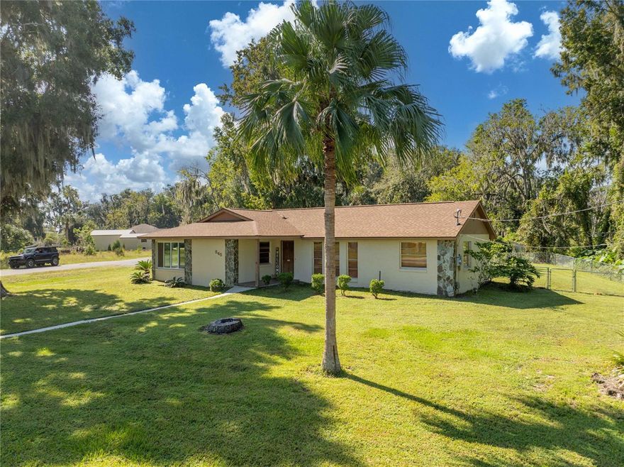 Situated on an oversized corner lot just off the shores of Lake Panasoffkee, this charming 3BR/2BA home offers the perfect blend of privacy, space, and Florida lifestyle. With a newer roof, fresh paint, and a fully fenced backyard, this move-in-ready residence features over 2,000± sqft of living area, including an enclosed Florida room overlooking the tranquil waters of Lake Panasoffkee. The kitchen is beautifully appointed with ceramic tile floors, dark cabinetry, solid-surface countertops, stainless-steel appliances, and a convenient closet pantry. Constructed of durable concrete block with stucco finish and decorative flagstone accents, the home exudes quality craftsmanship throughout. Elegant laminate flooring flows through the open layout, complemented by abundant storage and thoughtfully designed spaces. Outdoor living shines here with a spacious screened lanai, large fenced yard perfect for entertaining, and a storage shed for all your tools and toys. Enjoy the best of lake life—just grab your boat and explore the renowned 4,460-acre, spring-fed Lake Panasoffkee, famous for world-class fishing and natural beauty. With quick access to I-75 and the Florida Turnpike, you’re only minutes from The Villages, Ocala, Tampa, and Orlando. More than just a home, this property offers the lifestyle you’ve been searching for—peaceful, convenient, and full of possibility. Don’t wait—opportunities like this don’t last!