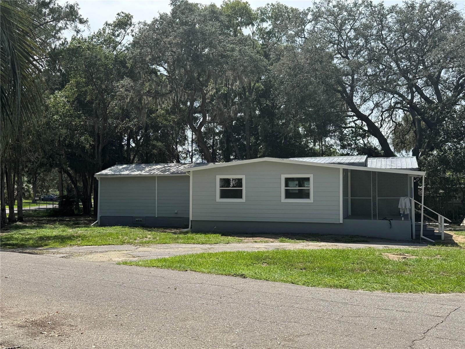 Quiet streets and corner lot. Remodeled 2 bedroom 1 bath with Den/office on .21 acres. New Ac and remodeled through out. kitchen with soft closing doors. stainless steel appliances. Inside washer and dryer. Storage pantry or closet. walk in shower with upgraded fixtures. Owners entry from 4x8 raised deck. Enjoy the natural light and welcoming color pallet of this updated home. Outside features front and Back porch and 16 x 20 shop on concrete pad. Rv parking space and extra concrete pad for desired use. Plenty of mature shade Cedar tree's for those warm Florida sunny days. Set your tour today. " Florida, Love Where you Live"