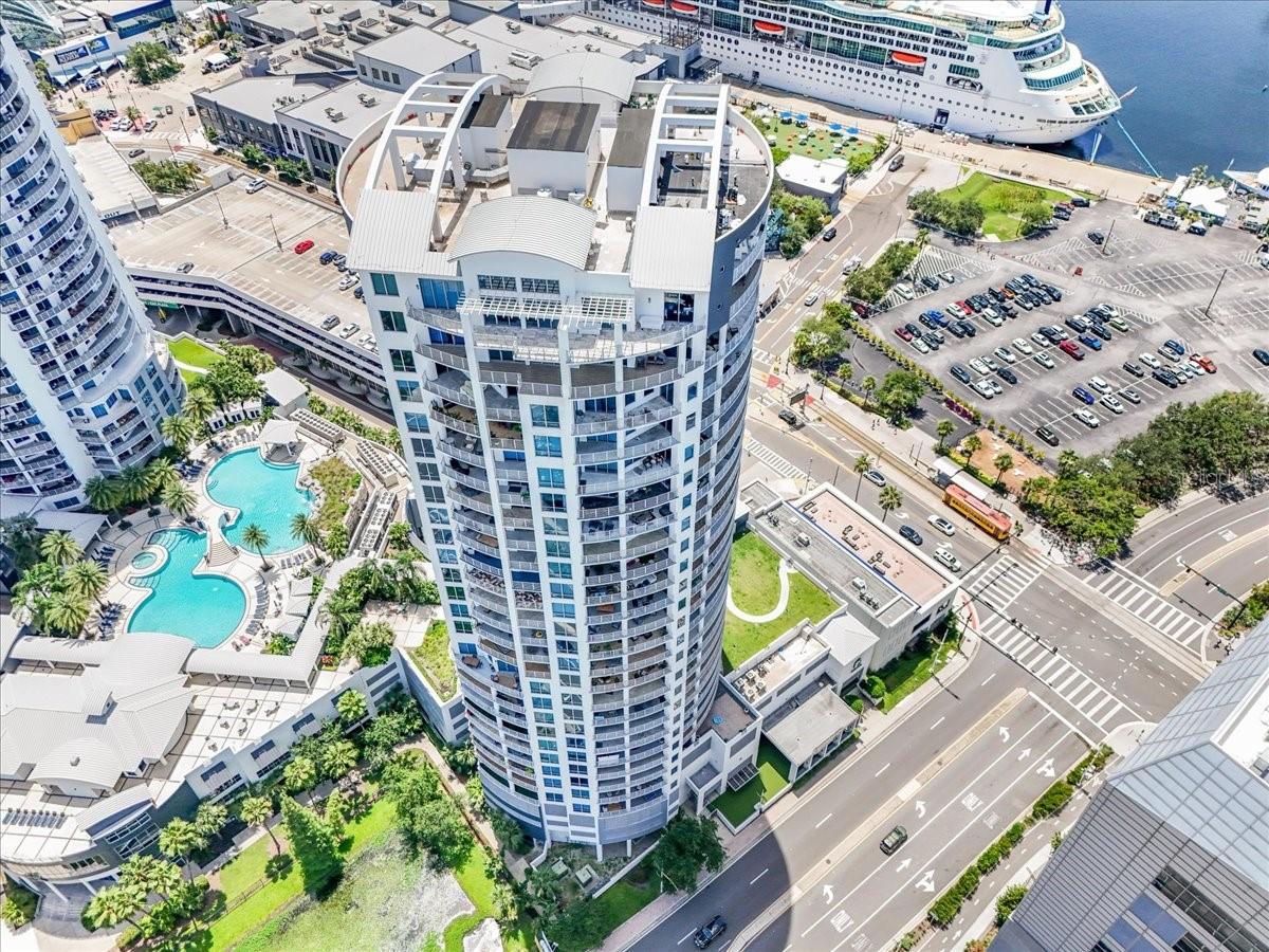Step into Elevated Living — A Rare Jewel in the Heart of Tampa Bay. Perched high on the 11th floor, this one-of-a-kind luxury residence is more than just a home—it’s a front-row seat to the beauty, energy, and evolution of Tampa’s most iconic skyline. From the moment you enter, you’re enveloped by breathtaking, panoramic views that sweep across the sparkling Bay waters, Water Street’s architectural marvels, the vibrant activity of cruise ships, and the serene charm of Harbour Island. Sunrise to sunset, your view becomes a living masterpiece—unfolding in real time from your private, expansive wraparound terrace. This is not your average two-bedroom condo. This is the largest Two-Bedroom Master floor plan offered in either tower, designed to rival—and even surpass—the space and flow of many three-bedroom units. Every inch of this residence is meticulously crafted for both comfort and elegance. Two generously sized master suites boast spa-inspired ensuite baths, massive walk-in closets, and direct terrace access for seamless indoor-outdoor living. A stylish powder room offers convenience for guests, while thoughtful upgrades such as rich hardwood floors, tray ceilings, custom crown molding, and granite countertops lend timeless sophistication throughout. The chef-inspired kitchen is a culinary haven, appointed with premium finishes, stainless steel appliances, and tile flooring that blends beauty with durability. Whether you’re hosting a candlelit dinner overlooking the skyline or enjoying a quiet morning coffee as the city stirs below, every moment here is wrapped in luxury. Additional highlights include two secured garage parking spaces, with extra room for a motorcycle or additional storage, and a large, private storage unit for your seasonal or lifestyle essentials. Set on a low-density floor for added peace and privacy, this residence belongs to one of Tampa Bay’s most coveted high-rise communities—offering resort-style amenities, security, and a lifestyle tailored to those who demand the very best.
This is more than a property—it’s a rare opportunity to claim a signature piece of Tampa’s evolving skyline.
Turn the key and elevate your life.