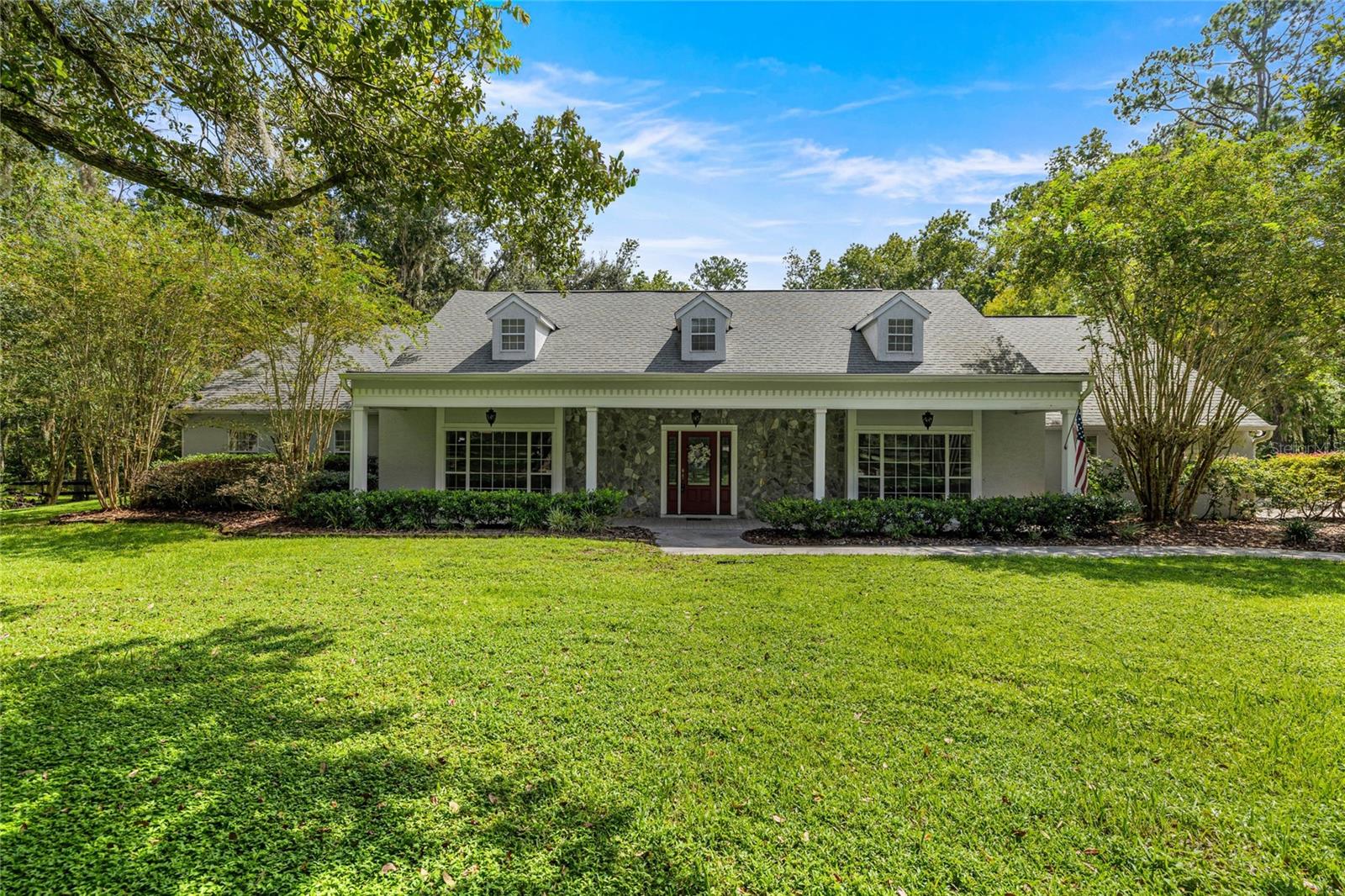One or more photo(s) has been virtually staged. Welcome to a true sanctuary of sophistication and serenity, nestled within the prestigious gated community of Summit II in Southwest Ocala. This extraordinary 2.5-acre estate blends elegance with privacy, beginning with its own private gated entrance that sets the tone for exclusivity from the moment you arrive. Spanning nearly 3,800 square feet of thoughtfully designed living space, the residence offers four spacious bedrooms, four and a half luxurious baths, a dedicated office, and both formal and casual living areas—perfectly curated for both intimate evenings and grand entertaining. The remodeled kitchen is a culinary masterpiece, showcasing gleaming stainless-steel appliances, a farmhouse sink, a generous center island, and modern finishes that inspire gourmet creations. A custom bar with wine cooler elevates the dining experience, while the remodeled primary bath provides a spa-inspired retreat designed for ultimate relaxation. An expansive family room anchored by a fireplace invites cozy gatherings, while the outdoor oasis rivals a luxury resort. A sparkling saltwater pool with hot tub, complemented by a screened enclosure, invites effortless year-round enjoyment. The park-like grounds, enhanced with an oversized driveway, 3 car garage, and pre-wired shed, ensure both beauty and practicality. This A1-zoned property offers not only refined living but also peace of mind, with newer appliances, updated air conditioning, and countless thoughtful upgrades throughout. Situated just minutes from fine dining, equestrian venues, and the cultural treasures of Southwest Ocala, this estate harmonizes convenience with privacy. Indulge in the rare opportunity to own a residence that embodies timeless luxury, modern comfort, and enduring value.