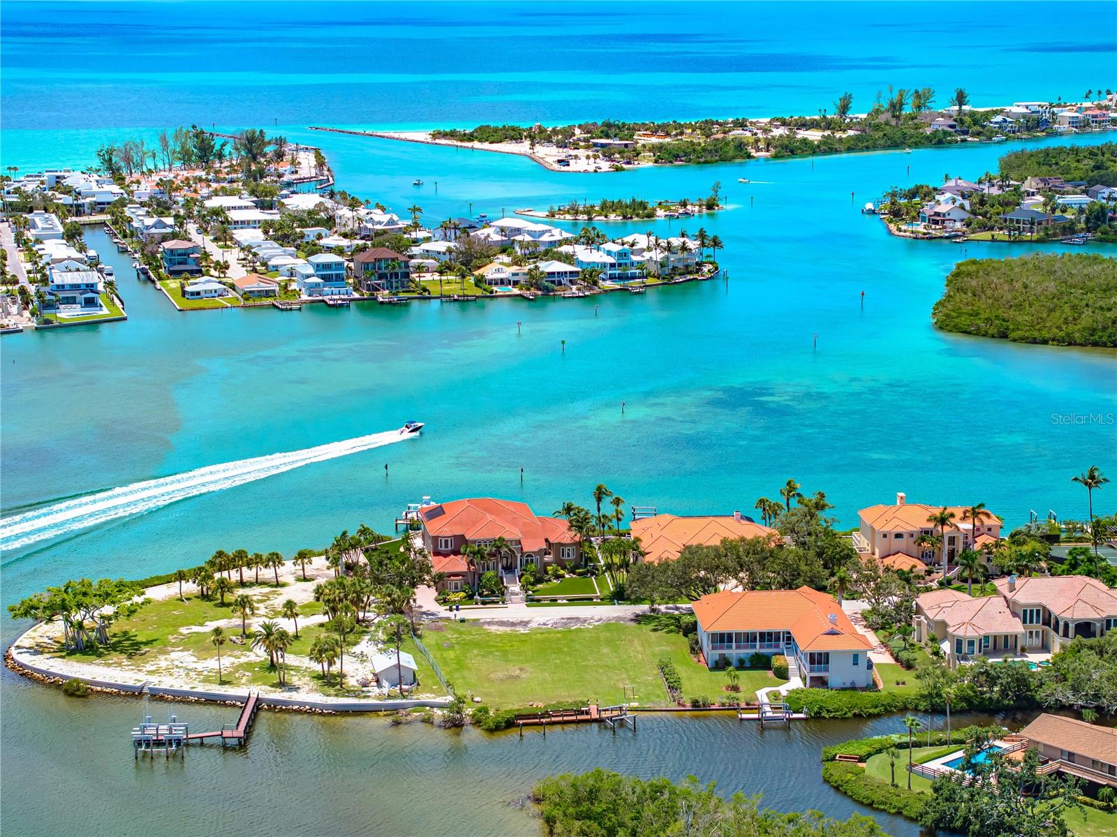 Welcome to one of the most exclusive and breathtaking waterfront properties on Florida’s Gulf Coast. Nestled within the prestigious Enchanted Isles, a private, gated island enclave with fewer than 20 residences, this extraordinary vacant parcel offers nearly 17,000 square feet of prime real estate to craft your custom luxury estate. Enjoy panoramic full bay views and direct access to world-class boating waters. With over 100 feet of pristine water frontage, a 55-foot private dock, deep water well, and an included 10,000 lb boat lift, this is a true boater’s paradise. Anglers will love the fantastic fishing right off the dock, while nature lovers will be captivated by sightings of ospreys, playful dolphins, and gentle manatees, turning every moment into a serene escape. Set sail to your favorite waterfront dining spots or cruise out to Snake Island and the Venice Jetty in less than 5 minutes, with endless adventures just around the bend. Despite its tucked-away island feel, U.S. 41 is just minutes away, offering quick access to shopping, dining, and all the conveniences of modern living. Don’t miss this rare chance to build your dream home in a setting so stunning, tranquil, and private it feels like a hidden paradise.
