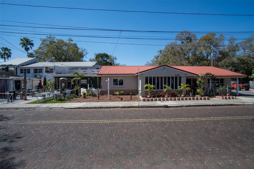 Back On Market, Huge Price Improvement! Here's your chance to acquire a Corner Lot featuring a blend of commercial and residential spaces, along with a storage house, situated in the captivating locale of Safety Harbor on Main Street and 5th Ave. This unique property represents one of the last few remaining single-family residences in Safety Harbor's Market Place, positioned on the ground floor with an impressive 210 feet of road frontage on 5th Ave and over 48 feet on the Main Street corner. Safety Harbor, a flourishing waterfront community renowned for its Safety Harbor Spa, marina, parks, shops, and restaurants, offers an enticing backdrop for this property. The sale includes two parcels. The first parcel, located on Main St and 5th Ave N, comprises 3 buildings totaling 3,083 square feet. The corner building on Main St and 5th Ave boasts excellent exposure featuring 924 square feet, 2 spacious showrooms, 2 bathrooms (one handicap accessible), and a back room. Currently leased and occupied by tenants. The second building offers an open space of 595 square feet, currently rented for storage. The third building is a beautifully updated 3-bedroom, 2-bath home spanning 1,456 square feet, characterized by an open floor plan, porcelain tile, a modern kitchen with rainforest marble, updated baths and master walk-in closet. Included in the sale is a parking lot on 5th Ave N, measuring 60x58 square feet per public record, providing 12 parking spots. These properties fall within the Main Street Marketplace Section of Safety Harbor and are zoned for MULTI-USE commercial purposes as per the City of Safety Harbor. Notably, the area is in Zone X, eliminating the need for flood insurance. The property presents an excellent opportunity for developers considering construction possibilities of up to 35 feet with storefront and living space above, or for business owners recognizing the value of Main Street property in Safety Harbor's rich history. While the owner will not subdivide the land, post-purchase, there is potential to break the property into three parcels through proper permitting with the city. Seize this chance to own a piece of downtown Safety Harbor and become part of its vibrant history!