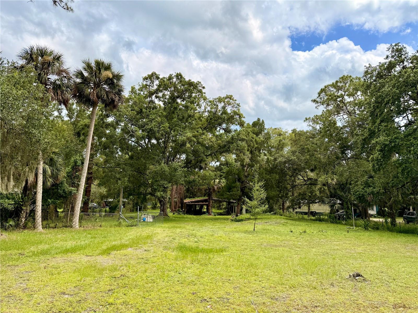 This 1-acre parcel of opportunity is a clean slate for your vision—whether you’re planning a custom single-family home or a manufactured home, this property welcomes both. With a new power pole and well pump already in place, much of the prep work is done. 30 Amp hookup already in place. Just bring your camper to stay in while you build your beautiful new home. Pole barn can be enclosed for storage. While the septic tank has been removed, the space is ready for your next steps.Zoned for horses and other agricultural animals, this land is perfect for those dreaming of a rural lifestyle with room for animals and gardens. Enjoy the convenience of a central location, nestled between Orlando and Titusville. You’re just 30 minutes from the Space Coast’s beautiful beaches, giving you easy access to both city life and coastal charm. Don’t miss the chance to create your own piece of Florida paradise!