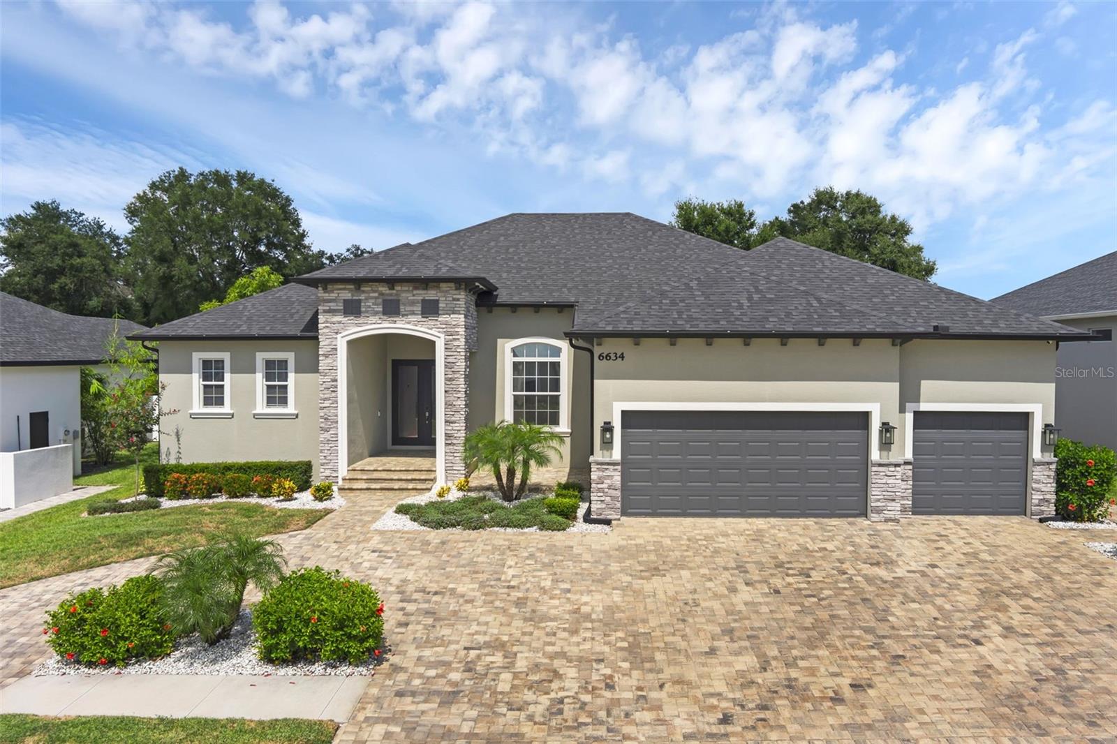 Welcome to your private retreat in the highly desirable gated community of Treymont in South Lakeland. Built in 2022, this exquisite 5-bedroom, 3-bathroom single-story home offers nearly 3,000 square feet of elegant, open-concept living space designed for both comfort and entertaining.Step inside to discover soaring ceilings, premium tile flooring, and an expansive layout that seamlessly connects the main living areas. The heart of the home is a chef-inspired kitchen featuring high-end stainless steel appliances, stone countertops, a large center island, and a walk-in pantry—perfect for hosting or daily living. The split-bedroom floor plan ensures privacy and flexibility. The luxurious primary suite features a spa-style en-suite bath with dual vanities, a tiled shower stall, a jetted tub, and a massive closet/storage space. Two additional bedrooms share a full bathroom with a tiled shower, while the remaining bedrooms are ideal for guests, a home office, or multigenerational living.Step outside to your private backyard oasis—a fully fenced sanctuary with a sun-drenched pool deck, two covered entertainment areas, and lush landscaping that creates the perfect setting for gatherings or quiet evenings. A sealed paver circle driveway adds curb appeal and convenience with ample parking space. Enjoy peace of mind in this gated community, which also offers a community playground for residents. Zoned for top-rated schools, and just minutes from dining, shopping, and medical facilities—this home truly offers the best of luxury and location. Located in the established Treymont community in Lakeland, FL, this home provides access to an exceptional lifestyle in a prime Central Florida location. Enjoy easy access to Lakeside Village, home to boutique shopping, restaurants, and entertainment. Commuters will love the proximity to the Polk Parkway, providing quick routes to both Tampa and Orlando. Nearby attractions like Circle B Bar Reserve offer scenic trails and wildlife experiences, while families benefit from high-performing schools and top healthcare providers like Lakeland Regional Health. Whether you're looking for outdoor adventure, career opportunities, or upscale suburban living, Treymont delivers it all.