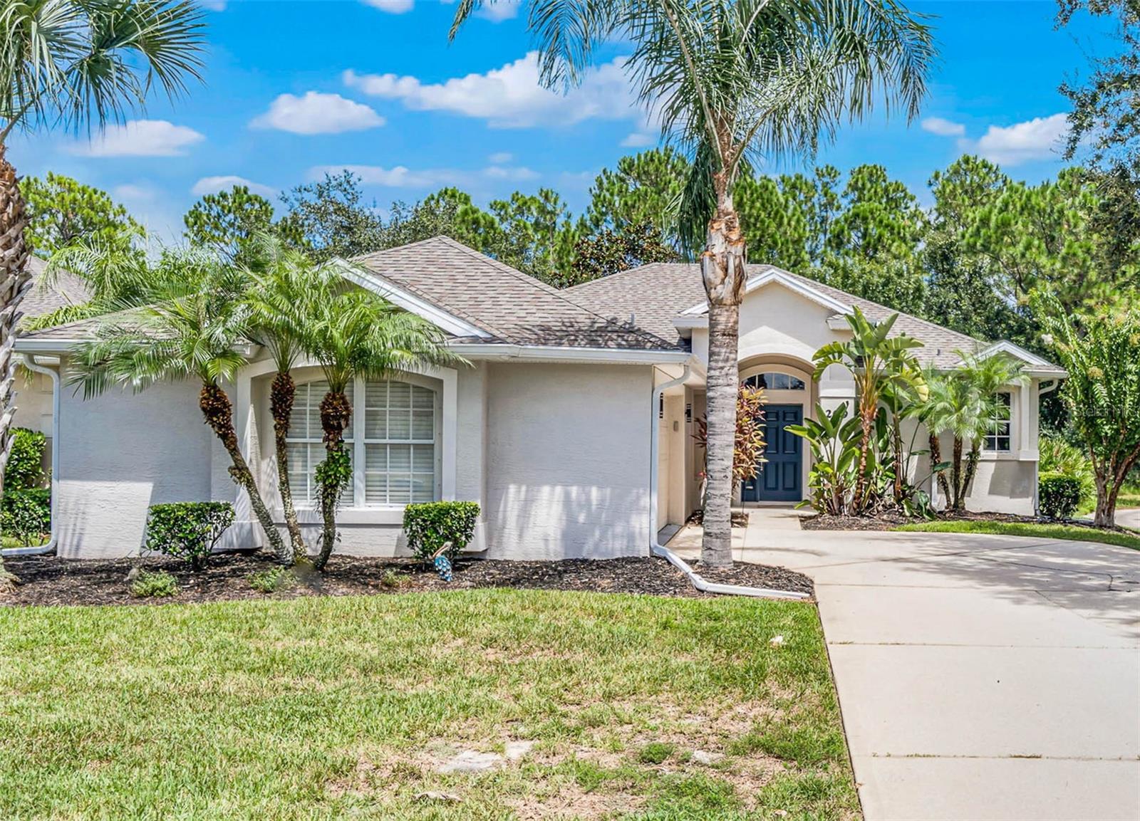 Stunning home in the exclusive community of LPGA International, ideally set on a premium lot along the 4th fairway of the Jones Course. This residence has been meticulously upgraded inside and out, offering a blend of modern style and everyday comfort. The open, split-bedroom floor plan features hardwood floors, custom closets, upgraded lighting, and ceiling fans. The chef's kitchen has been fully renovated with granite countertops, a custom island, and a pantry with a spice rack, soft-close cabinetry, and stainless steel appliances. The luxurious primary suite includes a spa-inspired bath with quartz vanity, clawfoot soaking tub, walk-in shower, and elegant finishes, while two additional bedrooms share a beautifully updated guest bath. The private backyard retreat has no rear neighbors—perfect for peaceful mornings with coffee while enjoying the scenic wooded and golf course views. Major system upgrades include a roof & gutters (2021), A/C (2022), and water heater (2021). Additional highlights include Hurricane shutters, a Ring doorbell, a keyless Schlage entry, an oversized garage with epoxy flooring, newer interior doors, and mature landscaping. Residents of LPGA International enjoy low HOA fees that include weekly lawn care and trimming, plus optional access to a world-class lifestyle. The Optional Club membership offers two championship courses designed by Rees Jones and Arthur Hills, along with a state-of-the-art clubhouse, restaurant, bar, saltwater pool, fitness center, and event space. Well-maintained, move-in ready, and motivated seller priced to sell, don't miss this opportunity! Call today to view this amazing home.