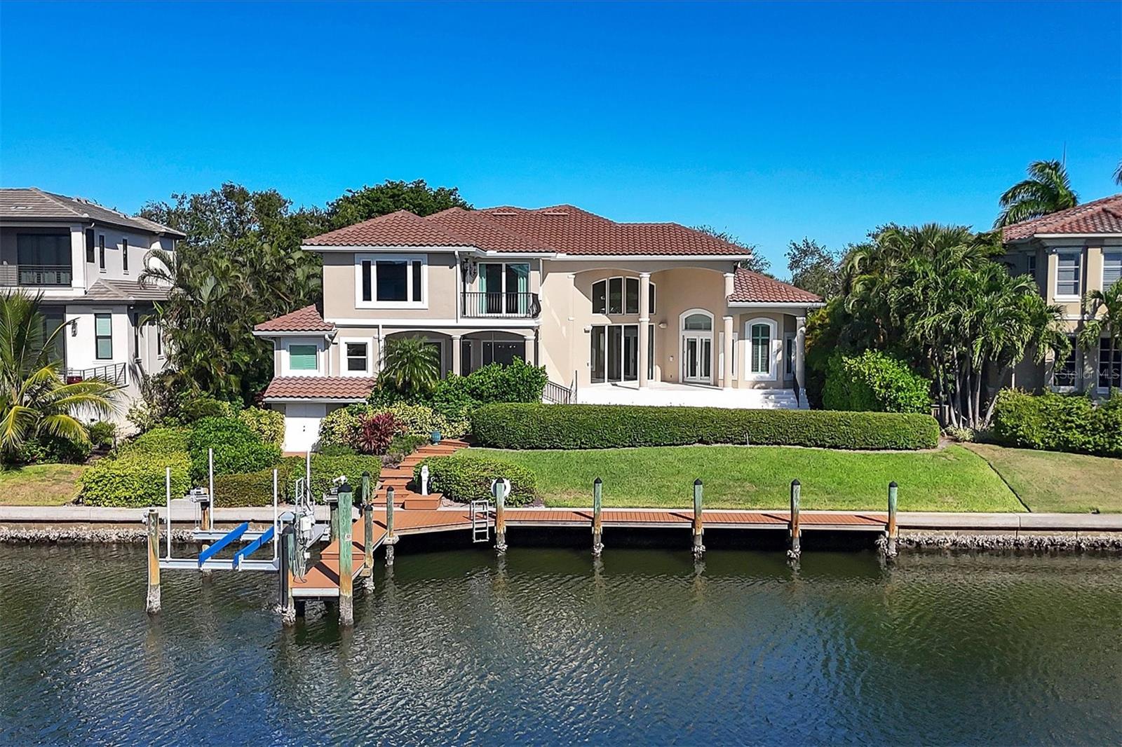 NEW LIST PRICE!!! NOW IS THE TIME, if Island living has been part of a lifelong dream, then you need to live on Longboat Key, one of the best islands rated by Travel & Leisure magazine and this is the PERFECT HOME TO TURN YOUR VISION INTO REALTY. This custom-built home offers convenience, exclusivity, privacy and is situated on deep water canal cul de sac street in the southernmost Harbor area of Bay isles behind 2 gates, perfect for a large family. It has been renovated to include the most desired features by todays discerning Buyers. It begins with the open floor plan and totally renovated chef style kitchen with top of line ss appliances by Wolf, Bosch, Sub-Zero and dual dishwashers by KitchenAid. Now add the safety features that make the home more hurricane resilient with impact windows & whole house generator. Located on over 1/4 acre, protected, deep water south facing lot on Sarasota Bay & built at an elevation over 12' exceeding the required base flood elevation. Say yes to a boater’s paradise with your recently added 100' of trek deck and dock with 10,000lb. boat lift that previously accommodated a 27’ Grady White cruiser. You're within minutes to easy access of Gulf of Mexico either via New Pass or Longboat Key Pass with no fixed bridges to hamper your voyage whether going fishing or just on a sunset cruise. The lot is lushly landscaped and meticulously cared for while the saltwater pool and spa have been recently refinished, the pool deck has newly added shell stone pavers. Now that you've been impressed with the curb appeal of this home, it is time to enter and be greeted by the soaring 24 ft. step ceiling in the foyer and main living area that is complimented with accented stone walls and floor to ceiling windows that showcase views of the pool and waterway. The chef’s kitchen with a large island, extensive wood cabinetry has easy access to the 22’x28’ Dining Rm/Family Rm combination that makes entertaining family and friends easy. The Breakfast Nook is perfect for more casual intimate dining for the owner or on those perfect days move to the 15’x27’ screened in porch and outdoor kitchen taking advantage of the view. Hosting those overnight Guests is no problem with this 5/6 bedroom and 5 ½ bath home. 3 of the Guest Bedrooms are En Suite while 2 share a full bath, each of these bedrooms are on different levels achieving the ultimate in privacy for your guests. The Owners’ Master on main level is oversized with a sitting area, the Master Bath has his/her vanities, a separate perfect makeup vanity that conceals the disappearing tub, and his/hers closets with wood organizers. Beautiful engineered hardwood flooring is on the main level, 6” baseboard and multi-piece crown molding in the main living area. This 3-level home offers great views of the Bay from the different decks and porches plus provision has been made for a future elevator, just add all the electro-mechanicals. Most of the key infrastructure items like a 5-year-old tile roof, A/C systems have recently been replaced and the exterior of home has been freshly painted. All it needs is a new family to enjoy all the benefits of the meticulous and thoughtful previous owners. Conveniently located at the Southern end of LBK with easy access to St. Armands and Downtown Sarasota. Longboat Key Club Resort membership offers fine dining, tennis, 2 golf courses & other benefits. Bay Isles gives you private beach access to the Gulf of Mexico, parking & facilities.