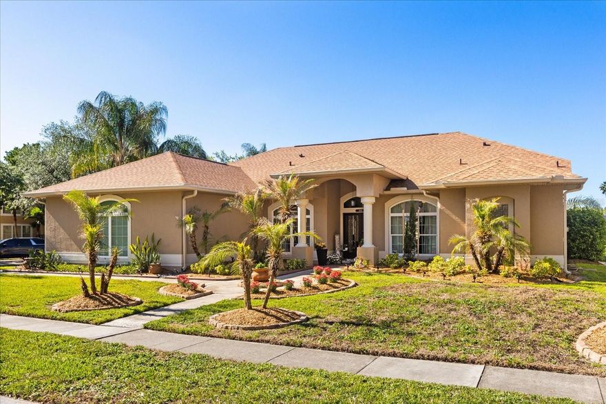 Welcome to this beautifully maintained single-story home situated on an oversized corner lot, offering a spacious layout, thoughtful updates, and a truly standout outdoor setting. Inside, you’ll find a bright and open floor plan with multiple living areas designed for both everyday living and entertaining. Large windows—updated in recent years—bring in abundant natural light throughout, while updated light fixtures provide a fresh, modern feel. The home also features a real wood-burning fireplace, adding warmth and character to the main living space.
The kitchen flows seamlessly into the main living and dining areas, and the flexible layout offers options for a home office, media room, or additional living space. The fully upgraded primary bathroom serves as a private retreat with high-end finishes and a clean, modern design.
Step outside to one of the home’s most impressive features—a true backyard oasis. Mature palm trees, a peaceful pond view, and a screened-in pool area create a private setting that’s perfect for relaxing or entertaining year-round. The pool is surrounded by pavers, enhancing both functionality and overall appeal. Major updates include a new roof (2022), HVAC system replaced in 2019, windows updated in recent years, and updated lighting throughout, offering added peace of mind.
Located near shopping, dining, and major roadways, this home offers a combination of space, upgrades, and outdoor living that is truly special.