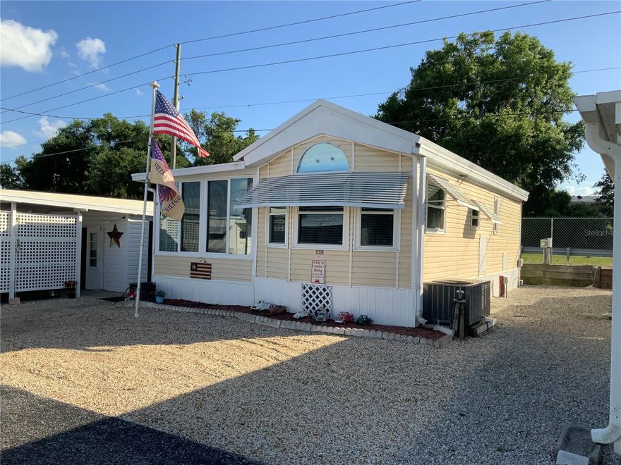 This is one great place to make all yours.  This updated park model home is ready for immediate occupancy.  Partial furnishings make this home move in ready with all appliances included, furnishings, televisions and so many other items.  This community is located on the shores of beautiful Lake Yale with it's own community boat ramp and boat slips.  The home improvements include double pane storm windows with warranty, new luxury vinyl plank flooring, newer A/C and heat  and new main access door.  There is space for many vehicles to be under cover with a single car carport and a massive 24x44 separate carport area.  Just beside the home is a shed that has been converted into an entertainment space for fun with the family and friends to include a television, refrigerator and plenty of room for sitting around socializing or throwing some darts.  This is a must see property for this community with the property consisting of 3 lots.