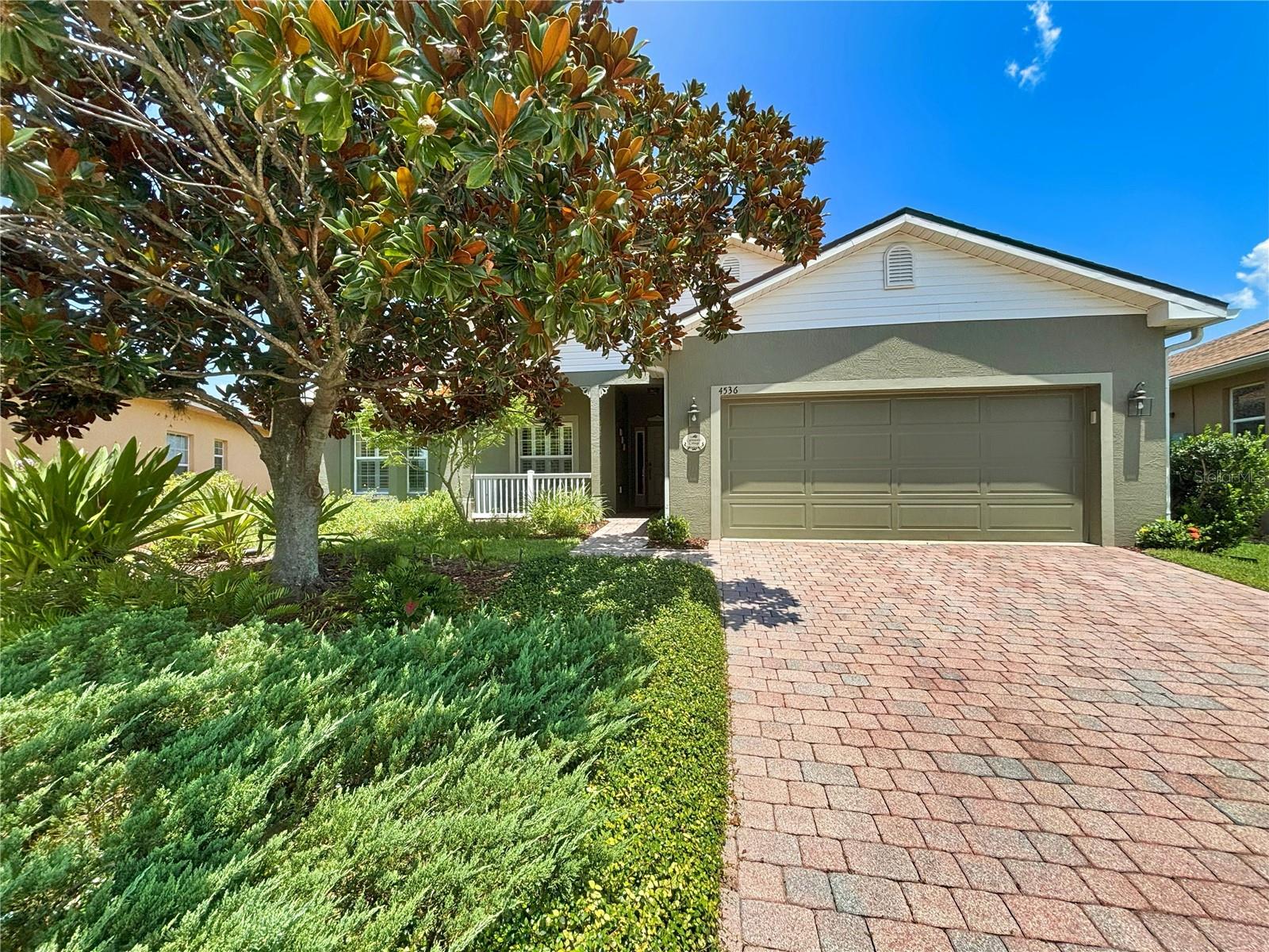 One or more photo(s) has been virtually staged. 4536 Turnberry Lane, Lake Wales, Florida is a GARDNERS DELIGHT! It's a rare find in Lake Ashton. NEW ROOF (2023) AND A/C (2022).This home is located on an oversized lot with lush landscape in the front and back of the home. This Hemingway floorplan offers 2 bedroom / 2 bath with Den and is surrounded by natural beauty. For those looking for a bit more space in the rear yard, this home could be just what you've been waiting for. It’s the perfect opportunity to just relax and enjoy the benefits of a mature garden. Trees, bushes, flowers, and even a fountain offer a unique experience. Beyond the picturesque setting, the home has newer vinyl plank floors in the master and guest bedrooms. A separate irrigation meter is a benefit with lawn maintenance-- SAVING YOU MONEY. The living room is spacious and triple sliders offer an unobstructed view of the back yard as you enter the home. The Den has bookshelves for the avid reader, plantation shutters and decorative carpet. It's the perfect room for golf memorabilia or book collection. The Den could be used as a bedroom or craft room. too. The guest bedroom and bathroom are both adequate in size and conveniently located within the home. The primary suite with plantation shutters offers a large walk in closet, primary bath with double sink vanity, walk in shower and linen closet. Lake Ashton is a gated community with 2- 18 hole golf courses (memberships not required to reside in Lake Ashton), large clubhouse with outdoor pool, movie theater, bowling lanes, card and billiard rooms, and media center. Bocce courts, memorial area and outdoor pavilion are located in close proximity to the main clubhouse. The Health and Fitness Center features a large indoor lap pool, multi-purpose room, 1/2 court basketball (indoor), full court racquetball (indoor), pickle ball courts, tennis courts and more. Residents enjoy two eating venues, Charm City and the Eagles Nest. Make your appointment to tour this home and this beautiful Florida Active Adult Retirement community.