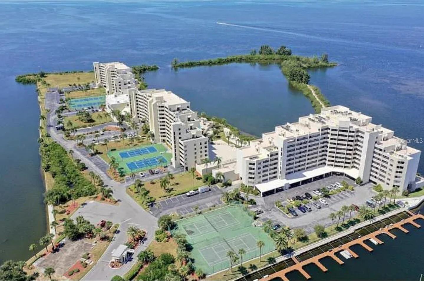 Are you ready to enjoy the Florida lifestyle? Ready to swim or kayak alongside dolphins or manatees? This turnkey 1 bed / 1 bath waterfront condo at Gulf Island Beach & Tennis Club serves up postcard views—Gulf waters to the horizon—and easy, coastal living. Light and breezy inside, it’s beautifully furnished and sold fully equipped (kitchenware, linens—just bring a suitcase). A generous living area opens to a walk-out patio/balcony so you can sip your favorite beverage and watch the sky glow at sunset. Storage-smart kitchen with ample cabinetry keeps everything tidy.
The community is guard-gated 24/7 with weekday on-site management and a long list of amenities: heated pool, tennis & pickleball, beach area, fishing, nature trail, fitness rooms with men’s & women’s lockers, aerobics room, plus a grand lobby & game room (tables, piano, dance floor) and an active social calendar. Marina nearby; dock restoration underway. Convenient access from the parking lot or garage makes coming and going easy, and you’re minutes from restaurants, parks, and Tampa Bay attractions. (HOA fee may include Internet & Cable—buyer to verify inclusions.) Come see why this community feels like its own slice of Florida paradise.