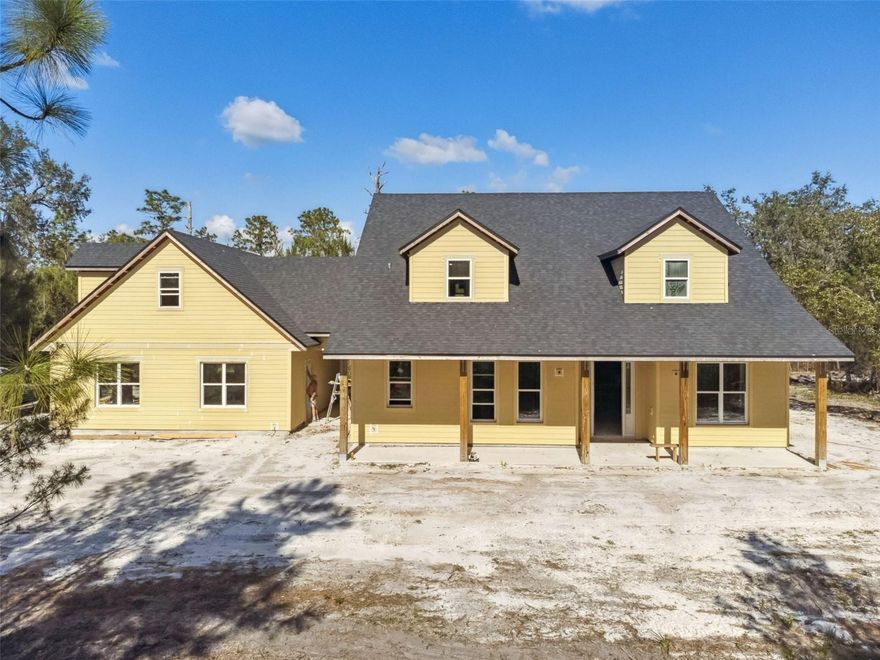 One or more photo(s) has been virtually staged. Under Construction. Lender Credit of 1% (of loan amount) toward closing costs or rate buy-down (inquire for more info). Discover the perfect blend of peaceful country living and modern by owning this BRAND-NEW, CUSOTM BUILT two-story home by 5R Construction. This stunning home is tucked away on a private 5-ACRE homesite and offers the tranquility of rural life while being just minutes from shopping, dining, and all that the Orlando area has to offer. From the moment you arrive, a picturesque 720 ft. winding asphalt millings driveway leads you to this thoughtfully designed home. A spacious covered front porch with tongue and groove ceiling welcomes you inside, where comfort and elegance meet with every detail. The open-concept first floor features a luxurious primary suite, providing a private retreat with ease of access. Entertain with ease in the expansive living area and enjoy a well-appointed kitchen showcasing stylish shaker cabinets, granite countertops, and a full suite of included appliances — refrigerator, cooktop, double oven, microwave, washer, dryer, and even a water softener. The kitchen flows seamlessly into the main living space and onto the large covered back porch also with tongue and grove ceiling, ideal for relaxing or entertaining outdoors. A separate dining area awaits for family gatherings, along with a den/study that could also be used as a fourth bedroom and a convenient half bath located nearby. Also downstairs is a spacious laundry room with washer and dryer included. A breezeway connects the main home to a two-car garage, topped with a versatile bonus room — perfect as a future guest suite, studio, office, or recreation room. The breezeway itself offers build-out potential to add even more flexible living space. Upstairs, you'll find two secondary bedrooms, each with their own bathroom, thoughtfully arranged for comfort and functionality. The community is zoned for horses and has an optional HOA. With easy access to Highway 50, the 417, and I-95, commuting is a breeze, yet the setting remains quiet and serene — the best of both worlds. Enjoy the benefit of top-tier Seminole County school zoning, including Walker Elementary, Chiles Middle, and Hagerty High — all highly sought-after for their academic excellence. And the best part? There even may still be time to select some of the home’s finishes and personal touches to truly make it your own! Don't miss this rare opportunity to own a brand-new custom home in a peaceful setting just outside the city. Schedule a visit today and imagine the lifestyle that awaits.