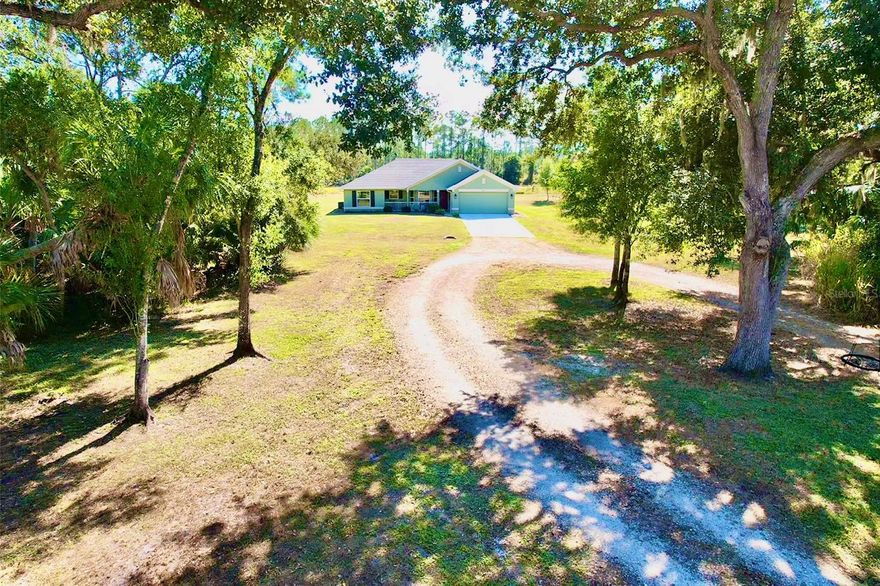 Nestled on 3 beautiful acres in the sought-after North Port Estates, this stunning 3-bedroom, 2-bathroom home, built in 2020, offers the perfect blend of modern comfort and peaceful country living. The property features a gated entryway leading to a cleared lot accented by mature oak trees and lush, established landscaping. Inside, the home boasts new solid-core vinyl flooring and hurricane shutters for added security and peace of mind. The spacious lanai provides a relaxing outdoor retreat overlooking the serene surroundings. Two well-maintained sheds offer ample storage, with one featuring a loft for extra versatility. A thoughtfully designed chicken coop adds a charming touch for those seeking a self-sufficient lifestyle. Additional highlights include generator hook-up and a desirable location along a nice, wide ditch that enhances drainage and privacy. This property offers the rare opportunity to enjoy space, tranquility, and modern convenience—all just minutes from the heart of North Port.
