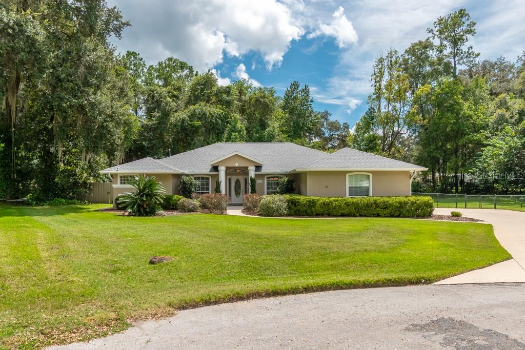 Welcome to this beautifully updated 4 bedroom, 2.5 bath home situated on a private ½ acre lot with a fully fenced and professionally landscaped yard. The highlight of this property is the completely remodeled screened pool featuring elegant glass tile, travertine stone decking, a covered outdoor lanai, outdoor shower, and half bath —perfect for year-round entertaining.
Inside, cherry hardwood floors flow throughout the home. The living room boasts vaulted ceilings with expansive views of the pool, while the spacious kitchen opens to the great room and features stainless steel appliances, granite center island, and an extended counter with bar seating. A separate dining room adds to the home’s appeal.
The huge master suite offers a relaxing sitting area and spa-inspired bath with a soaking tub, walk-in shower, and dual vanities. Generously sized guest rooms and an updated main bath with marble counters complete the split bedroom plan. Additional conveniences include an inside laundry room with utility sink.
Recent upgrades provide peace of mind: new roof, fully replaced HVAC system with main heat pump and air handler, new hot water heater with on-demand system, water softener, 22KW Generac generator with 500-gallon underground propane tank, and Ring surveillance system.
This home blends modern luxury with functional design—move-in ready and designed for comfort and style.