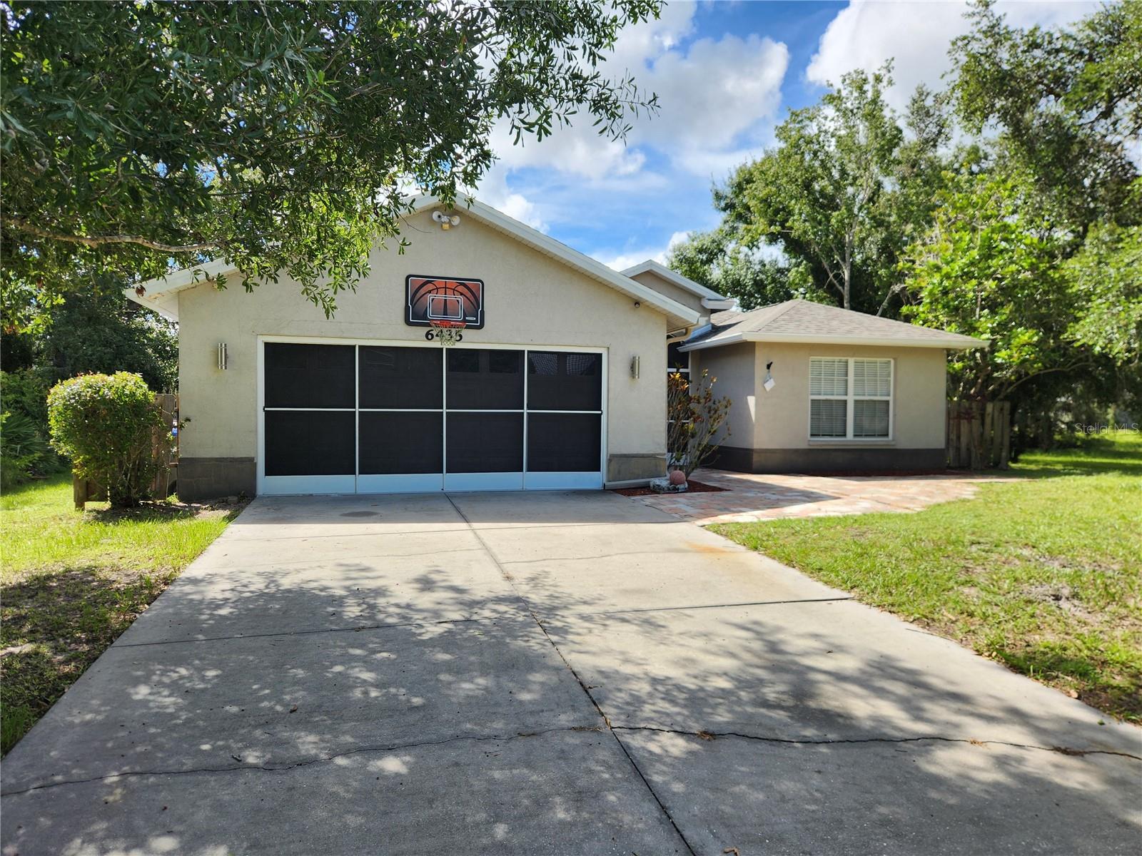 Spacious 3 bedroom possible 4th bedroom, 2 bath home on a Double Lot in a peaceful area of North Port. This home offers a brand new roof (2025), Mature Landscaping, a large screened in lanai, and beautiful screened front entry with brick pavers leading up to the home. The living room features Vaulted Ceilings, built in plant shelves and sliding glass doors to the lanai. The Eat -In Kitchen has a breakfast bar, bay windows, and recessed and decorative lighting. There is also an additional room with beautiful French Doors that can be used as a formal dining room or a den. The Primary Bath has a Walk In Shower, Cultured Marble Sink, and an area to sit and get ready. The 2nd and 3rd bedrooms offers carpet and fairly large closets. The garage has been converted into a 4th bedroom under air but can also be used as a Bonus Room, Craft Room or even a Man Cave or can easily be put back to a garage. The backyard includes three Storage Sheds! The Spacious Yard has so many possibilities! You could add a pool, BBQ Area, Fire Pit, just to name a few. This home is also close to I-75 great for commuting or a quick way to Gorgeous Florida Beaches! Find your sanctuary in this Stunning Home!