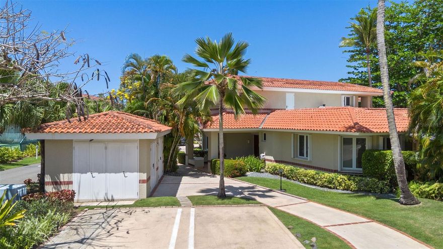 Experience the perfect blend of tropical elegance and modern comfort in this beautiful two-story corner villa, ideally located within one of the most exclusive resort communities, The Greens. With 3 spacious bedrooms and 3.5 bathrooms, this villa offers a serene retreat surrounded by lush greenery and stunning views of the newly renovated West Golf Course.
Step inside to discover an indoor-outdoor living space, ideal for relaxing or entertaining. The covered terrace enjoys a refreshing breeze, enhancing the tropical ambiance. Two well-appointed bedrooms are located on the first floor, while the expansive primary suite occupies the entire second level, providing privacy and tranquility.
The recently renovated kitchen is a chef’s dream, featuring stainless steel appliances, a center island with built-in storage, and stylish finishes. Additional features include space to store a golf cart, two designated parking spots directly in front of the unit, a 500-gallon water cistern, water softener system, electric shutters, an 11 kW backup generator, and 14 batteries that can power the home for uninterrupted comfort.
Residents of Dorado Beach Resort enjoy unparalleled amenities, including multiple golf courses, a state-of-the-art fitness center, scenic trails, the Sports Hub, gourmet restaurants, a waterpark, direct beach access, and much more. This villa has exclusive access to tennis courts reserved solely for community residents.
Don’t miss this rare opportunity to own a luxurious corner villa with resort-style living and golf course views.