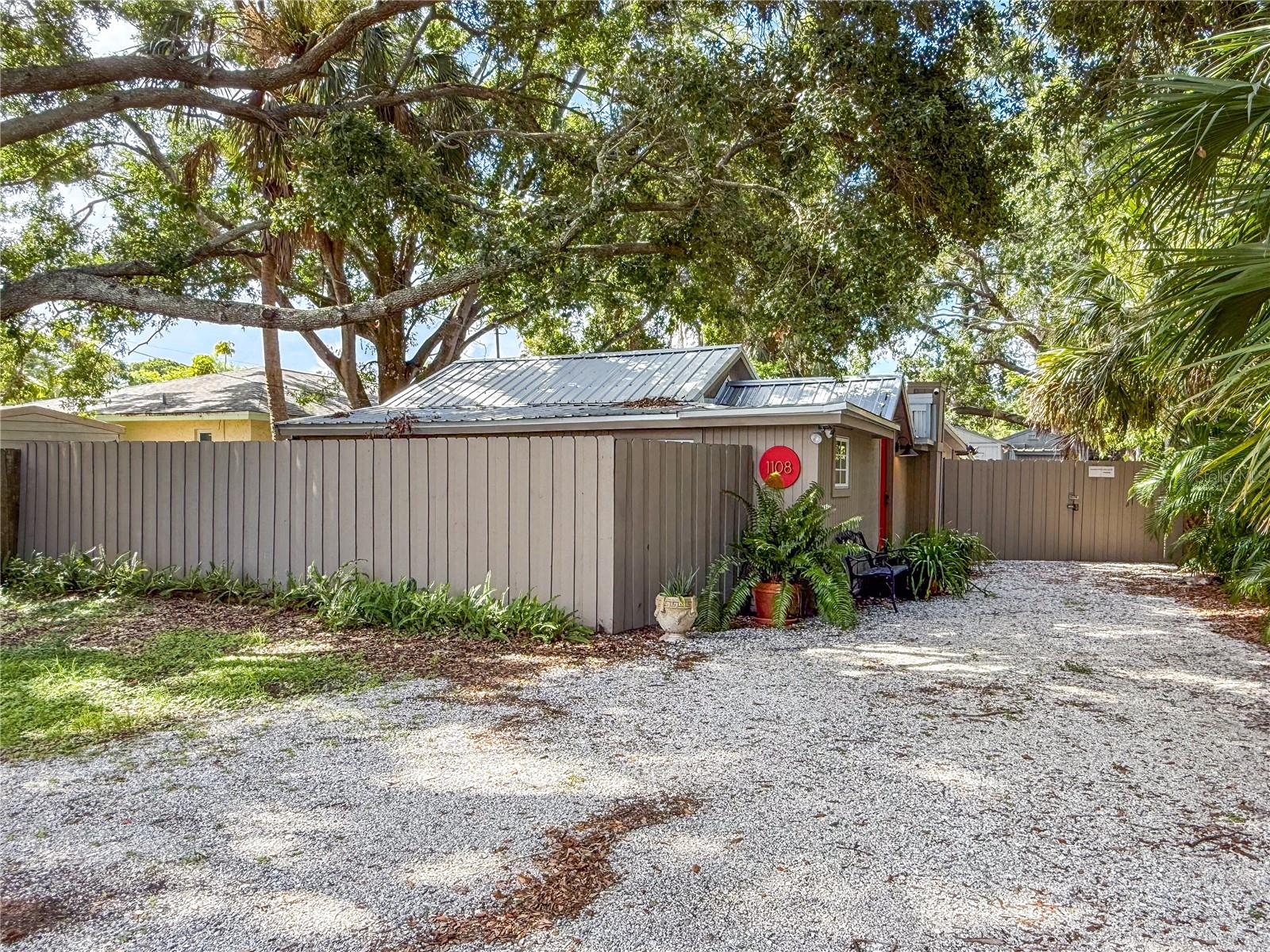 You are in for a real treat when you see this unique Craftsman-style bungalow where comfort and ease unite with old Florida charm. The ample fully-fenced lot with its natural plantings offers easy upkeep and a parklike environment in which to de-compress under calm and peaceful towering trees. Ringling College of Art and Design is in the neighborhood and Sarasota's vibrant downtown scene is minutes away. Upon entering the foyer of the main home (house is 750 sf), you will find a reading nook (could be a bedroom if wall opening is closed) and guest bedroom. Next is the main living area featuring cathedral pine ceilings over an open concept kitchen/dining/living area with abundant natural light. Primary bedroom is off this space. There is an attached enclosed screened lanai and an open deck (with outdoor shower) offering a wonderful place for al fresco dining or your morning coffee. Built in 1933 in the Highland Pines area of the Bayou Oaks neighborhood, this cozy well-preserved home with its tasteful modern updates is sure to be a hit for you and your fur babies. The detached guest cottage with 300 sf includes one bedroom, one bath and combo living, dining, and kitchen areas. The cottage could be used as an art studio or home office if not used as a rental. The cottage has its own screen porch. The primary house and guest house share laundry facilities. For additional storage, there is a shed adjacent to the guest cottage. Come enjoy the world-class beaches with crystal sand and turquoise waters of Lido Key, Siesta Key and Longboat Key. Sarasota offers many cultural offerings including the Ringling Museum, Asolo Repertory Theatre, Sarasota Opera House, Sarasota Ballet, The Van Wezel Performing Arts and more. Sarasota has an international airport, excellent hospitals, plenty of fine restaurants, golf courses, Selby Botanical Gardens and the like. Located in Flood Zone X. Sold turn-key furnished. Call to see this magical oasis.