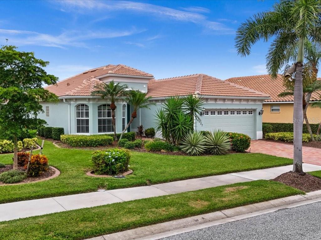 One or more photo(s) has been virtually staged. Discover serene lakefront living in the prestigious Heron Creek Golf & Country Club in North Port, Florida! This lovingly maintained 3-bedroom, 2-bath single-family home offers peaceful water views, a heated pool and spa with full screened enclosure, and lush tropical landscaping for added privacy and beauty. Step inside the 8' Double Entryway doors to find a bright and cheerful open concept layout with formal dining room and large Great Room with tray ceiling and 8' Tall Sliders to Lanai! The spacious Kitchen features newer stainless steel kitchen appliances, double undermount sink, deluxe raised panel cabinetry, granite countertops, and dinette area with Aquarium windows make it perfect for everyday comfort and entertaining. The built-in mirrored hutch and dry bar create a lovely backdrop whether you enjoy the formal dining experience or need flexible space for your Grand Piano! The Primary En-Suite is tucked away and features a tray ceiling, deluxe woodworking and trim, ceiling fan, oversized baseboard, large walk in closet with built ins and partition, a large bathroom with dual sinks, vanity area, tiled shower and water closet. In addition, you have two bedrooms, one sunny yellow with a fold-down desk from the closet, and the other shown as a home office with Executive Desk and credenza included! Other features include tile flooring throughout the main living areas, two in-floor outlets, luxury vinyl plank in the primary bedroom, freshly painted in a neutral coastal color palette, extra deep (31 feet) garage leading to Laundry Room with cabinets and laundry tub, architectural appointments inside and out, and a BRAND NEW TILE ROOF in 2024! Live the luxury lifestyle that comes with residing in this Arthur Hills designed Golf Course community, where more than 430 acres have been curated perfectly to balance environmentally protected nature preserves, expansive lakes and green space with the 18-hole Championship Golf Course. You'll be sure to enjoy the activities and events hosted at the elegant clubhouse, and have access to the fitness center, tennis courts, community pool, and more! NO CDD Fee, and LOW Quarterly dues cover lawn care, tree and shrub maintenance, irrigation water/system, INTERNET and Cable TV. Live, work, and play at Heron Creek—where every day feels like a getaway!