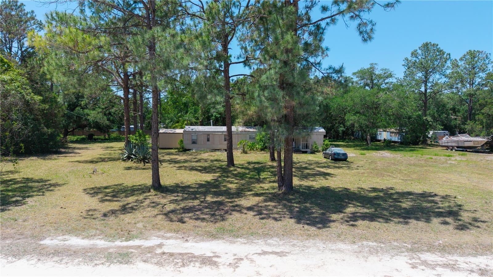 Welcome to your next big opportunity—2 acres of fully cleared land featuring two septic systems, a well, and impact fees already paid (buyer to verify with county). This versatile property includes a 2-bedroom, 2-bath 1972 mobile home that needs TLC but was occupied recently and offers a great starting point for restoration or temporary housing while you build your dream home. The lot also includes another trailer that will go with the property. Inherited by family members who have never lived on the premises, the property is being sold as-is. With potential to subdivide or simply enjoy the spacious lot as a single homesite (buyer to confirm all development options with the county), this is a fantastic find in a well-regarded subdivision. Enjoy the convenience of being just minutes from the Suncoast Parkway, offering an easy commute to Tampa and surrounding areas. Whether you're looking to invest, redevelop, or restore, this property delivers on potential!