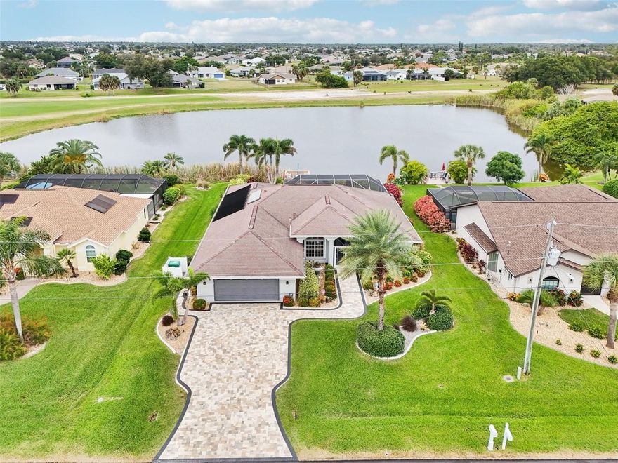 Exceptional Quality and Design in Every Detail in this Expansive Lakefront Rotonda West Home! Located in the X flood zone, this custom-built Anthony Fiore home offers a perfect blend of craftsmanship and comfort. The paver driveway and walkways, beautifully maintained landscaping, oversized garage with screened door, and welcoming double-door screened entry create an inviting first impression. Step through the etched glass double doors into an open floor plan featuring a welcoming foyer, 3 bedrooms, 2.5 bathrooms, vaulted ceilings, a formal living room, formal dining room, and a spacious family room. Abundant natural light fills the home through multiple windows and pocketing glass doors in both the formal living and family rooms. Tile flooring throughout the main living areas adds an elegant touch. The well-equipped kitchen features ample cabinetry, granite countertops, a large raised breakfast bar, a cozy breakfast nook, and decorative plant shelves. The primary ensuite bedroom includes sliding doors that open to the pool area, a tray ceiling, and a large walk-in closet with a built-in organization system. The primary bathroom offers a frameless glass-enclosed step-in shower with a built-in bench, a soaking tub, and a dual sink vanity. Both guest bedrooms feature generous closet space, while the guest bathroom includes a large walk-in shower and oversized vanity. A versatile bonus room with built-in cabinetry provides the perfect setting for a home office or hobby space. The interior laundry room is thoughtfully designed with cabinets and a laundry sink for added convenience. For entertaining or relaxing, the outdoor living space truly shines. The large screened and pavered lanai features a saltwater heated pool and spa with Pentair automation, as well as a half bathroom for added comfort. Just outside, a paver walkway leads to the dock, where you can enjoy the peaceful lake views, local wildlife, and breathtaking sunsets. Additional highlights include an insulated, air-conditioned garage with epoxy-coated flooring, workbench, storage, and a hurricane-rated insulated door. The home also features a whole-house water filtration and softener system with reverse osmosis drinking water, Storm Smart remote-controlled hurricane shutters and sunshades on the lanai, accordion hurricane shutters on the windows, a portable generator with relay switch to the power panel, central vacuum, lake-fed irrigation system, security system, low-voltage landscape lighting, and the option to purchase the home furnished. Located in the deed-restricted community of Rotonda West, this home offers access to 26 miles of waterways, outdoor recreation, social events, nature trails, nearby beaches, boating on Lemon Bay and Boca Grande, and world-class fishing. You’ll also be close to a wide variety of local restaurants, tiki bars, shopping, medical facilities, and more. Don’t miss your opportunity to own this extraordinary property at 13 Clubhouse Road, a home that truly has it all.