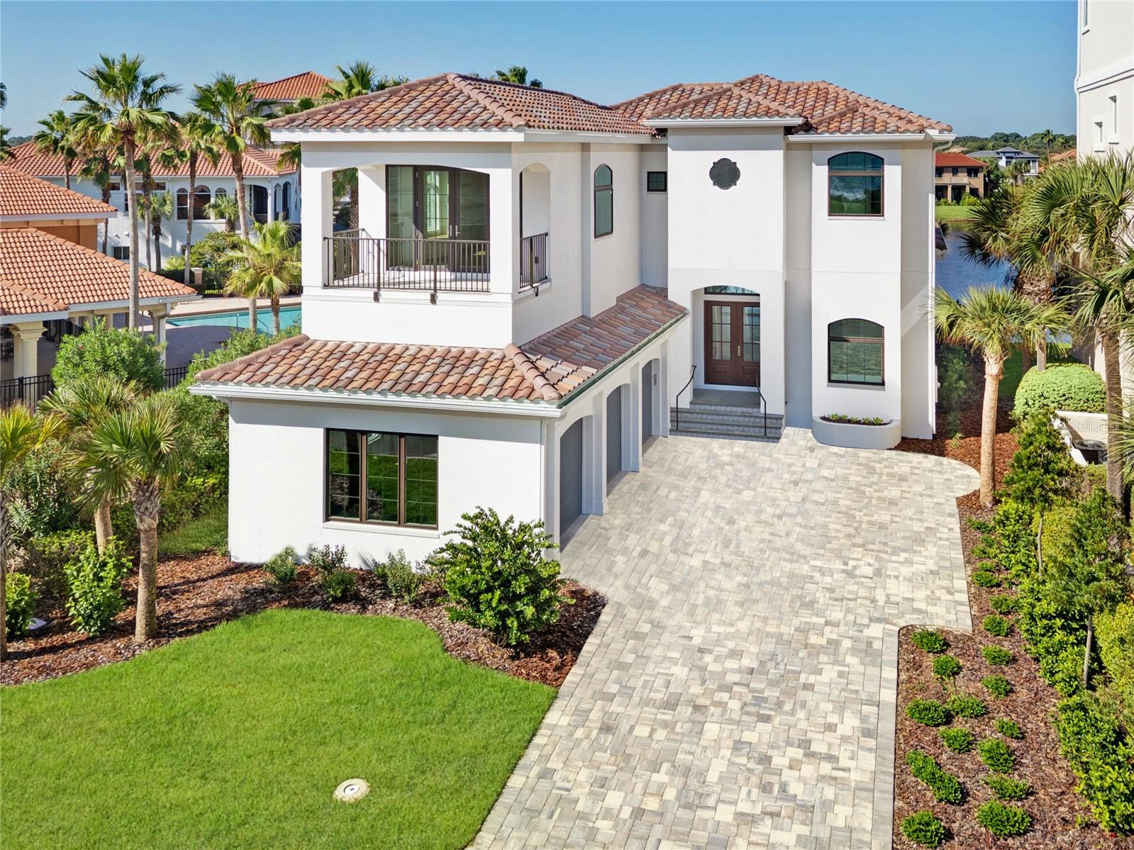 Indulge in unparalleled sophistication with this magnificent Blue Water masterpiece, situated in the prestigious Ocean Hammock community. Every element of this newly constructed home has been thoughtfully curated to seamlessly blend timeless elegance with modern functionality, offering an exceptional living experience like no other. This exceptional 4 bedroom, 4 bathroom and 3 Car Garage home is located right across from the beach access. Take a short stroll to the beach and enjoy a refreshing dip in the cool pool. At the heart of the home, the custom kitchen showcases hand-painted tile work, marble countertops, a 48" dual-fuel stove, a convenient microwave drawer, and low-voltage lighting under cabinets for a warm, modern ambiance. The main living area boasts striking 24x48" tiles imported from Spain, adding a touch of European sophistication. The open floor plan of the first living is ideal for everyday life or hosting your family and friends. Also, conveniently on the first level boasts the primary suite with two walk-in closets. Italian hardwood flooring graces the primary suite and upstairs, complementing the marble tile accents that flow throughout the home. Step into the spa-like bathroom, complete with Toto Nexus toilets, a steam shower, and thoughtfully placed under lighting cabinets. Custom molding adds an air of refinement throughout the house, while the custom wood staircase and railing create a grand focal point. Designed for ease and organization, the home features custom walk-in closets and shelving, and even a dedicated dog wash station for your furry companions in the mud room. Upstairs showcases the other bedrooms with ensuites, one being a perfect option for an office or 4th bedroom with a balcony facing East ideal to feel the ocean breezes while the sun comes up. Outdoor living is equally impressive, with custom rear patio stairs and planters that blend style and practicality. From the back patio and balcony, you will be able to soak in the stunning sunset views while overlooking the lake. This home is truly a masterpiece of craftsmanship, offering a seamless blend of luxury and comfort in every corner. It's more than a home—it's an experience waiting for you. Living on Hammock Beach Circle comprises of a guarded community gate, community pool and beach access, and lawn maintenance all included in the HOA. You can also join the Hammock Beach Club for access to world-class amenities, pools, Golf Courses, restaurants and more! Expected completion in May.