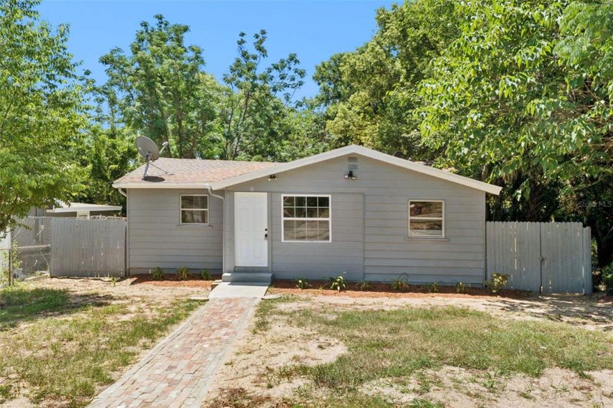 One or more photo(s) has been virtually staged. Tucked beneath a canopy of mature trees in the heart of Apopka, this beautifully renovated 3-bedroom, 1-bath home with NO HOA blends modern upgrades with everyday comfort—and it’s designed to instantly feel like home.

Step inside and you’re welcomed by a versatile foyer-style entry—perfect as a cozy sitting area, home office, or creative flex space—before it opens into a bright, open-concept living and dining area. The seamless layout makes it easy to entertain, connect, and enjoy everyday living all in one space.

The home has been thoughtfully upgraded with a brand-new tankless water heater, new electrical panel, and a new A/C system—giving you peace of mind for years to come. Luxury vinyl flooring flows throughout the main living areas, while the bathroom and all three bedrooms feature tile flooring, offering both durability and effortless maintenance.

The bathroom has been fully modernized with a sleek walk-in shower, finished with tile and a glass door for that clean, spa-like feel. In the kitchen, a well-placed window invites in natural light while offering a view of the outdoors—creating a bright and welcoming space to cook and gather.

Step outside and you’ll find one of this home’s standout features: a spacious, fully fenced backyard with a brand-new wood fence—perfect for pets, gatherings, or simply enjoying your own private outdoor retreat. The surrounding trees not only add charm but help keep the property cool and shaded year-round.

Location is everything, and this home delivers. Phyllis Wheatley Elementary School is just down the street, making morning routines a breeze. Plus, you’re minutes from Apopka’s growing selection of parks, trails, shopping, and dining—while still enjoying a quiet, established neighborhood feel.

If you’re looking for a move-in-ready home with modern upgrades, a functional layout, and a spacious lot in a thriving area—this one checks all the boxes.