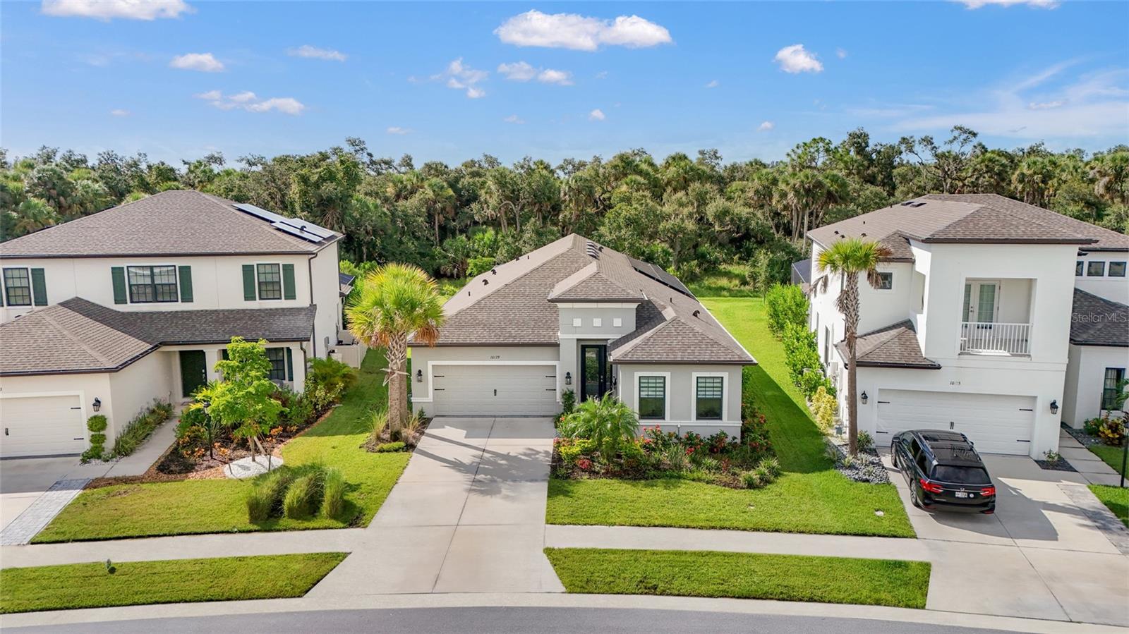 Welcome to the pinnacle of Florida luxury living—this 2022-built masterpiece offers over $200,000 in high-end upgrades and is nestled in the coveted, amenity-rich community of Skye Ranch. With 3 spacious bedrooms, a den, a separate office (could be fourth bedroom), and 3 full bathrooms, this home is designed to accommodate both everyday comfort and elegant entertaining.
Step through the dramatic, elongated entryway and be instantly captivated by sweeping views of the private lanai and natural conservation backdrop—framed perfectly by the Clear View Panel Cage. The outdoor oasis is unmatched: a winding, heated saltwater pebble tec pool with a tanning ledge, spa, and waterfall; outdoor kitchen with gas grill, wine refrigerator, and pizza oven; plus multiple areas for al fresco dining and sun-drenched lounging.
Inside, soaring ceilings, crown molding, and abundant natural light elevate every corner. The open-concept living room flows seamlessly into a gourmet chef’s kitchen featuring an oversized quartz island, gas cooktop, built-in oven/microwave, walk-in pantry, and a dedicated butler’s pantry. Every detail, from the upgraded lighting to the custom finishes, has been meticulously curated.
The primary suite is a sanctuary of its own, with tranquil views, a spa-inspired ensuite bath boasting a soaking tub, tile shower with built-in seating, and a dream-worthy walk-in closet that connects directly to the laundry room.
Enjoy eco-conscious living with an owned whole-house solar system and advanced water filtration and HVAC systems—including a mold scrubber ideal for allergy and asthma sufferers.
Skye Ranch offers an unparalleled lifestyle with miles of nature trails, playgrounds, sports fields, dog park, and the brand-new recreation center, The HUB, featuring resort-style pools, splash pad, fitness center, climbing wall, movement studio, café, and more. Plus, a brand-new K–8 school is opening in phases through 2027, right within the community.
This is more than a home—it’s a lifestyle defined by luxury, comfort, and connection. Don’t miss your chance to experience it.