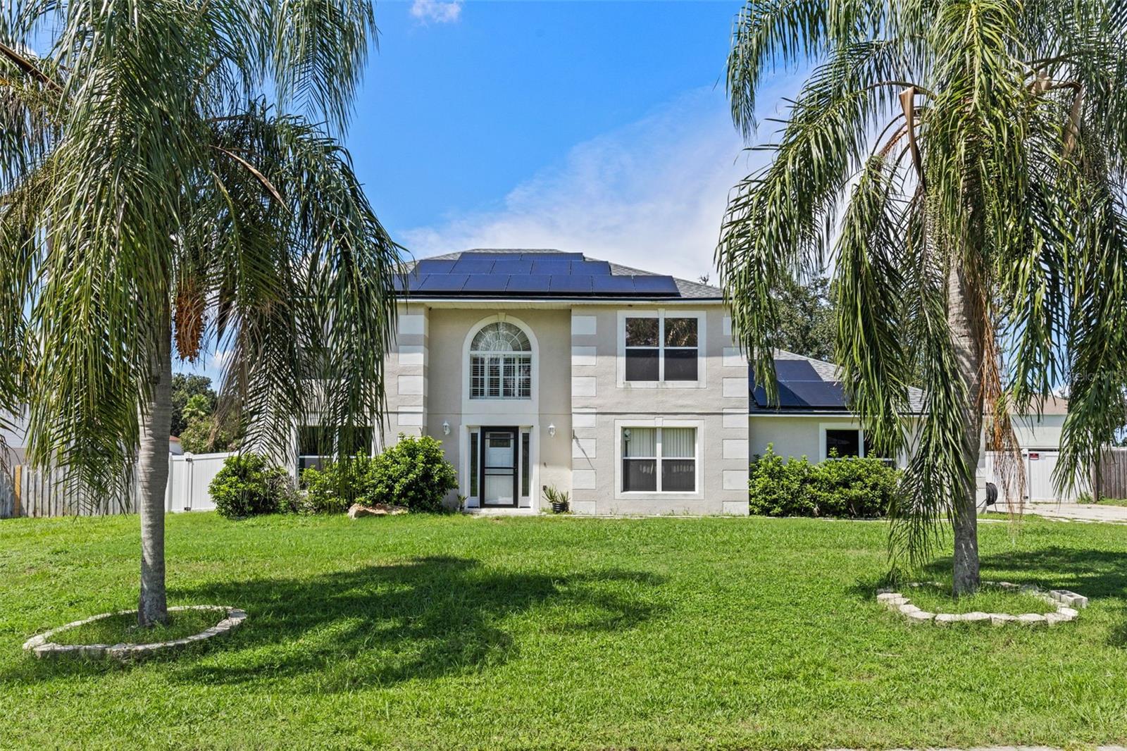 Welcome to a home where space, style, and versatility meet in the highly desired community of John's Lake Estates. This 4 bedroom, 2 ½ bath gem sits proudly on an oversized lot, offering privacy, curb appeal, and room to live life to the fullest. Step inside to soaring ceilings and sun filled spaces. The open concept living and dining areas connect effortlessly to a kitchen with stone countertops, and a must-have island. Need more room? The versatile bonus room gives you the flexibility for a home office, media lounge, gym, or playroom. The crown jewel at this home is the stunning screened in pool and spa, and plenty of deck space for entertaining. Imagine weekends grilling with friends, refreshing swims, and peaceful evenings soaking in the spa under the stars.The primary suite is your private sanctuary, featuring a walk in closet and an inspired bathroom. Three additional bedrooms ensure everyone has space to unwind. And for car lovers or hobbyists — the huge 3 car garage offers storage for vehicles, gear, and projects, plus extra driveway parking for guests. THIS IS MORE THAN A HOUSE — IT'S A LIFESTYLE UPGRADE. Plenty of room inside and out, a sparkling pool and spa to enjoy every season, and a location that keeps you close to everything yet feeling worlds away.