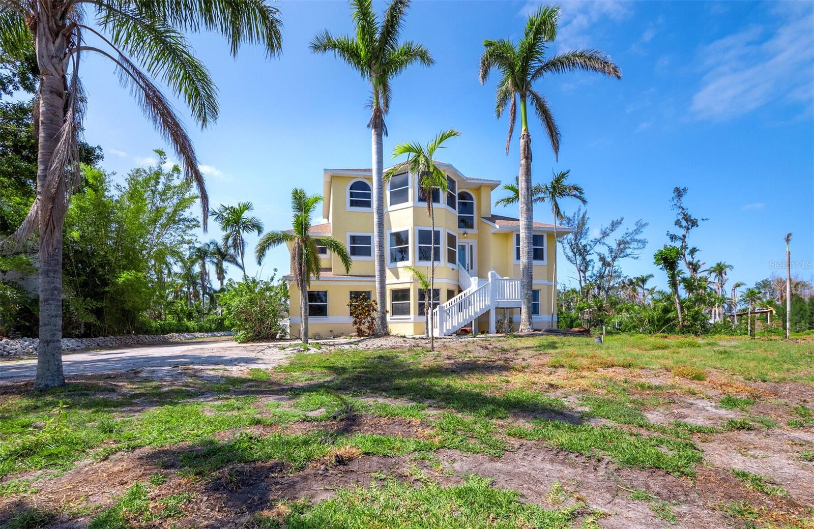 Welcome to your coastal retreat along Palma Sola Bay. Set on over 3 acres of private, lush land, this stunning three-level home captures the very best of Florida living. This home offers 3 spacious bedrooms and 2.5 baths, including a private master suite with a bonus room that offers endless possibilities for a home office, playroom or guest space. The gourmet kitchen is a chef's dream flowing seamlessly into the family room, perfect for everyday living and entertaining. This home features multiple screened porches and balconies, ideal for enjoying the bay breezes and watching the sunset. Venture up to the widow's walk for sweeping panoramic views of Palma Sola Bay, a truly special spot to start your morning or unwind at the end of the day. The expansive yard offers plenty of room for friends and pets to play, family gatherings or even future additions. This is the optimal home for families looking for space to grow, make memories and live the ultimate Florida lifestyle. Don't miss the opportunity to make this beautiful Bayfront property your forever home.