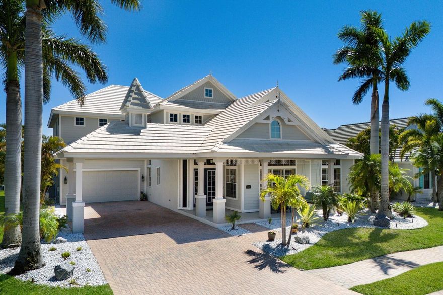 Step into refined coastal living in this five-bedroom residence with office and bonus loft, located within the gated boating community of Harbour Walk at The Inlets. Designed by Rutenberg Homes, this Key West–inspired property blends timeless architecture with modern functionality and direct water access—creating an exceptional opportunity for boaters and those seeking an elevated Florida lifestyle.

A welcoming front porch, porte-cochère, and three-car tandem garage introduce the home’s thoughtful design. Notable features include impact glass throughout, new storm shutters, a Generac whole-house generator, water softener, and a kitchen reverse osmosis system—providing comfort and peace of mind. Glass double doors open to a dramatic foyer anchored by a handcrafted wood staircase, flanked by formal living and dining rooms.

Inside, travertine flooring, cathedral ceilings, and expansive windows and sliders fill the home with natural light. The chef’s kitchen is equipped with custom cabinetry featuring glass display panels, stainless-steel appliances, granite countertops, and a center island with seating. The adjoining family room flows seamlessly to the outdoor living area, extending the home’s livable space by more than 1,200 square feet.

Outdoor living is a true highlight, with polyaspartic flooring spanning the lanai, front entry, and garage for durability and style. The covered lanai includes a summer kitchen with built-in gas grill, ideal for entertaining. The heated pool and spa feature a swim-up table and seating, all overlooking nearly 100 feet of canal frontage. A 22,000-lb boat lift offers quick access to the Manatee River, making this property ideal for boating enthusiasts.

The first-floor primary suite serves as a private retreat, offering a sitting area, terrace access, and a spacious en-suite bath. A dedicated office with custom built-ins is also located on the main level. Upstairs, a bonus loft with morning kitchen and private balcony overlooks the pool and waterway. Four additional bedrooms provide flexible accommodations, including one with a Murphy bed, two sharing a Jack-and-Jill bath, and a fifth with a private en-suite and walk-in closet.

Ideally located near Sarasota, Bradenton, and Lakewood Ranch, this waterfront home offers convenient access to dining, shopping, and cultural attractions. Award-winning beaches including Anna Maria Island, Longboat Key, and Siesta Key are just a short drive away, along with premier golf courses and marinas—delivering the very best of Florida’s coastal lifestyle.
