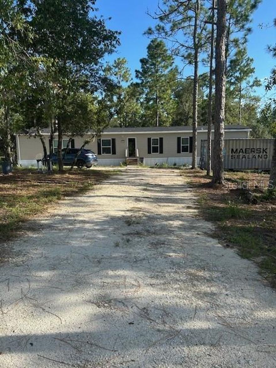 First and Foremost. LISTING AGENT IS THE PROPERTY OWNER! FORM GR-5x LICENSEE PERSONAL INTEREST form available. Home is a 2024 model, installed and provided a Levy County Certificate of Occupancy in March of 2024. Though listed as single wide it is 16 feet wide rather than 12 like most "single wide". It has no center seam to connect since at 16 feet wide it is a legally transported single unit. The well is 180 feet deep installed in 2023. Septic tank and drain field installed in early 2024. French drain running the width of the front of the home. Rain gutter with gutter screen across the front of the home with down spouts connected to the French drain. 1.25 Acres wooded corner lot. 160’ wide by 330’ deep. 2024 survey in hand. Bring all your pets from dogs and cats to horses and goats. No HOA, No lot rent, no traffic, no nosey neighbors, no stress! “X” Flood Zone designation, so no flood insurance requirements. FHA compliant skirting with 3 access points. 2025 FHA compliant foundation certification. 16 x 80 outside dimensions. 14 x 76 interior dimensions. 1064 square feet in A/C. Vinyl floors throughout. Lighted ceiling fans with remotes in living room and master bedroom. Double vanity and walk-in closet in “on suite”. Split floor plan with 2nd and 3rd bedrooms separate from main bedroom by kitchen dining and living room.
New French door Refrigerator/freezer with ice maker. Dishwasher New Disposal new Electric glass top range. Stainless hood. 
Central A/C with heat. Hall laundry area with washer and dryer. 8 x 6 metal building by well with, softener filter and scheduled electric power installation.