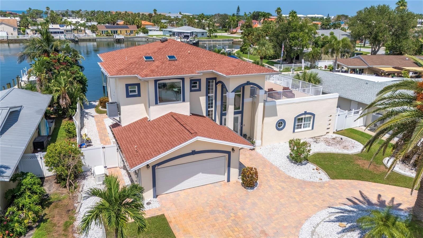 Belleair Beach Waterfront Estate. Indulge in the ultimate waterfront lifestyle with this recently remodeled Belleair Beach residence, perfectly positioned on deep water just minutes from the Gulf of Mexico—or take a stroll to your private residence beach access. This 4 bedroom, 3 bathroom coastal masterpiece blends refined design with modern functionality. The main level welcomes you with soaring ceilings, an open-concept living and dining area, and a modern kitchen framed by breathtaking water views. Three well-appointed bedrooms complete this level, offering comfort and versatility. Ascend to the second level and discover a private retreat featuring an additional living space and an expansive balcony ideal for sunset gatherings or easily converted to create additional living quarters. No detail has been overlooked: new wood-look tile floors, custom cabinetry, new baseboards and trim, and elegant finishes throughout create an atmosphere of coastal flair. Step outdoors to your personal paradise—lush tropical landscaping, a sparkling pool, and panoramic views of the Intracoastal. A private dock and boat lift provide effortless access for sunset cruises and weekend fishing adventures. Located near Clearwater beach, Belleair, Indian Rocks Beach that provides local restaurants, shopping & entertainment or take a quick trip over bridge to Pelican Golf Club and Belleair Country Club.