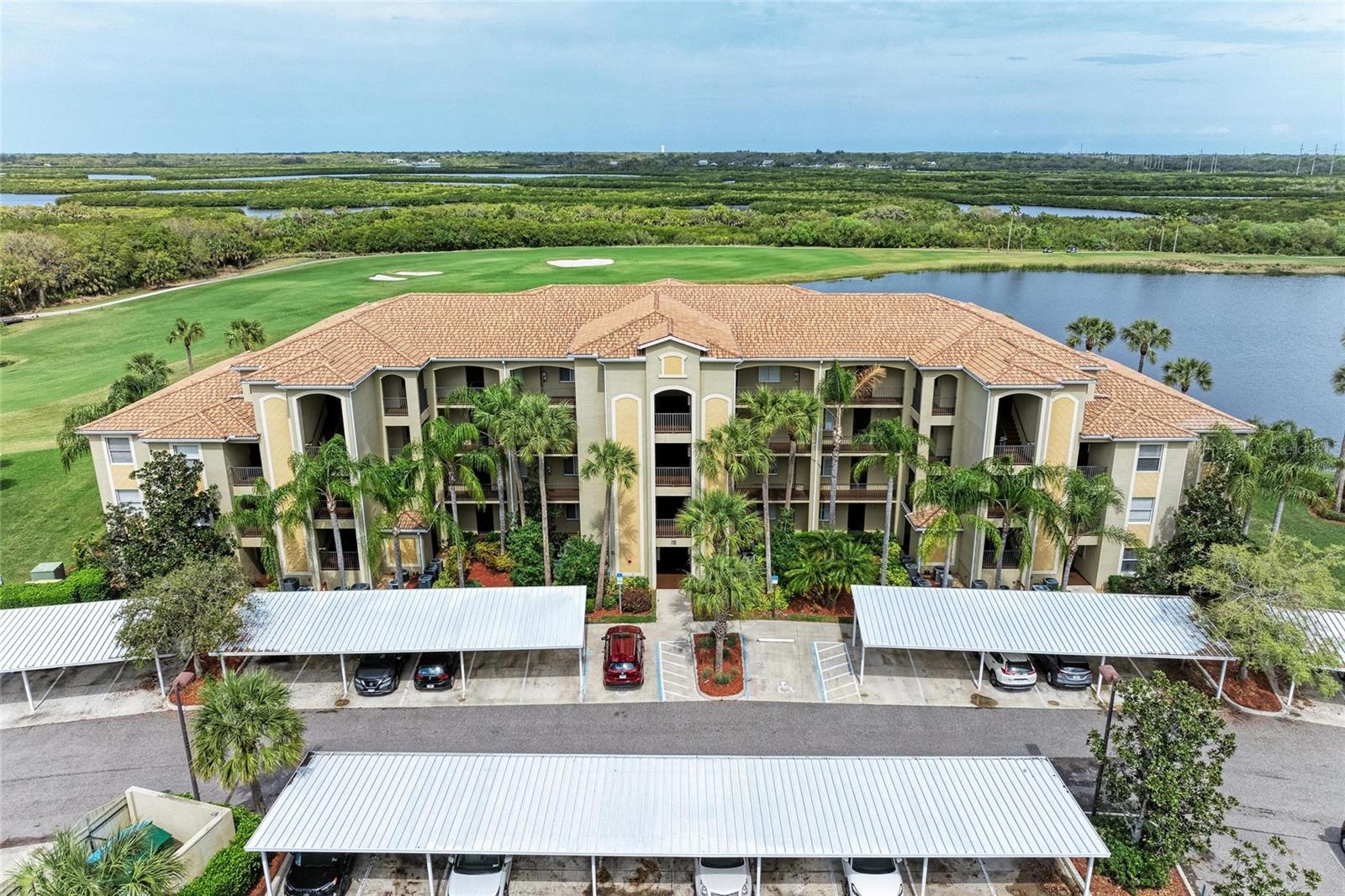 GOLF MEMBERSHIP INCLUDED- WITH BREATHTAKING VIEWS FROM THIS 2ND FLOOR TERRACE CONDO-OFFERED TURNKEY-SO JUST BRING YOUR SUITCASE! Welcome to River Strand Golf & Country Club, where refined elegance meets resort-style living. This beautifully appointed second-floor condominium offers an ideal balance of luxury, comfort, and natural beauty, all framed by sweeping views of a tranquil lake with lush preserve, fairways and privacy.
As you enter the screened entranceway to the condo take in the upgrades where ceramic tile set on the diagonal complements the open space and the living room with a feature painted wall and floating shelves add a decorative touch. The open feel of this floor plan is looking out of the sliders to the serene backdrop of vibrant sunsets and the gentle sounds of nature can be enjoyed on the spacious lanai with multiple screens and side views. Designed with effortless living in mind, this turnkey, golf-deeded residence boasts an open-concept layout with bright, inviting living and dining areas highlighted by upgraded lighting and a fresh neutral palette.
The kitchen is a chef’s delight, featuring rich wood cabinetry, granite countertops, newer fridge and stainless steel appliances with a breakfast bar perfect for entertaining. The charming breakfast nook has multiple windows bringing in plenty of light that look out to the lake views. The dining area, also with a featured painted wall is perfect for family gatherings. The thoughtful bedroom quarters are in the front with the spacious primary suite offering a walk-in closet and built-in closet that seamlessly lead to the master bath with a walk-in shower. The guest suite, currently styled with a queen bedroom set is conveniently located adjacent to the second full bath with a tub/shower combination with custom tub glass sliders.
An indoor laundry room with a full-size washer and dryer adds convenience, while a secure storage room directly across from the elevator—perfect for bicycles or golf clubs—and a covered carport complete the offering.
The lifestyle at River Strand is unmatched. Ownership includes access to the 27-hole Arthur Hills–designed golf course, Har-Tru tennis courts, Pickleball courts, a resort-style Pool with lazy river and Tiki bar, satellite pools, a grand clubhouse with dining and social events, two state-of-the-art fitness centers, and a community center. With 24-hour gated security and exterior maintenance included, every day feels like a retreat. Best of all, the special assessment for the clubhouse and restaurant renovations has been paid by the seller.
Perfect as a full-time residence or a part-time retreat with excellent rental potential (30-day minimum) this home is ideally located just minutes from I-75, Costco, Target and Hobby Lobby. The UTC dining and shopping district, downtown Sarasota, Bradenton, and the world-renowned Gulf Coast beaches of Siesta Key, Lido Key, Longboat Key, and Anna Maria Island are all within easy reach.
Experience the ultimate blend of sophistication, relaxation, and country club living at River Strand. Schedule your private tour today- Don't wait to start enjoying all the Florida has!