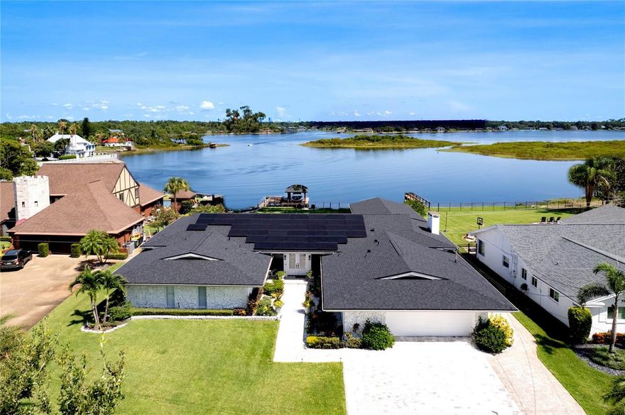 UNDER CONTRACT ACCEPTING BACK UP OFFERS$ BREATHTAKING PANORAMIC VIEWS THROUGHOUT YOUR  ENTIRE HOUSE, YOU'VE FOUND IT! MINIMAL POWER BILLS, FULL SOLAR HERE, (AND PAID OFF)! OPEN FLOOR PLAN WITH LUXURY DESIGN AND 10FT CEILINGS, YOU'VE FOUND IT! LUXURY LAKE HOME CLOSE TO EVERYTHING, MINUTES FROM THE AIRPORT! This captivating lakefront showcasing over 4000 sq ft of luxurious panoramic lake views throughout the entire house! Positioned on 100 ft of pristine lake frontage along the Conway chain, conveniently located near downtown Orlando, ORMC, 408, 528, and I-4 interstates; this location effortlessly combines tranquility and convenience. (Highly rated Cornerstone Charter Academy School nearby, with K-12 grades), & No HOA! Custom designed in 2022-2023 inside and out, fully renovated and upgraded in every way!
 The fully Heated Saltwater Pool & Jacuzzi completed in (2023), and ready for you to enjoy! Immaculately maintained and artfully designed, this extraordinary property showcases a New Roof in June of 2023,(42)New Solar Panels(2022) to keep your power bill down to a minimum, New Fence(2022), New Industrial Generac Generator(2022), & a 2 NEW HVACs & AC units, one in (2022), and (2023.) NEW irrigation system(2022), NEW hot-water heater(2023), and one of the few houses on this chain of lakes that has public sewer, without a septic tank in the front lawn. 
Inside culinary enthusiasts will delight in the presence of 2 stoves(electric and gas), 2 dishwashers, 2 refrigerators, 2 large kitchen islands, and a generously sized walk-in pantry, ensuring that every culinary endeavor becomes a joyous affair.

The master bedroom has 10ft ceilings, resort like lake views, offering a sanctuary of tranquility and luxury, with remote control blinds, featuring large his and hers walk-in closets, and a meticulously designed bathroom with exquisite his and hers vanities. Treat yourself to the large ensuite walk-in shower, complete with two separate shower heads for a spa-like experience within the comforts of your own home.
This exceptional residence truly encompasses every desirable feature, including two stunning family rooms. One boasts a cozy fireplace, creating an intimate ambiance for gatherings, while the other showcases PANORAMIC WINDOWS with enhanced by a full entertainment system. Largest Residential Saltwater Fish Tank in Central Florida, Optional to stay, and a custom built with a High Performance Speaker Entertainment Sound System! Garage has attic storage space, ceiling storage racks, and epoxy flooring with a separated air conditioned room.

Step outside and be enchanted by an OVERSIZED backyard oasis—a true paradise full of nature! Relax on the oversized boat dock equipped with a 7,000-pound boat lift, (2022).  Every detail thought out and customized.

This Modern Masterpiece is an absolute Must-See for those in search of the epitome of Luxury Lake Living. Immerse yourself in the unrivaled opulence and functionality that this home offers, where no detail has been overlooked. *Your Dream of lake living with your own private lakefront resort-style home awaits you!—WELCOME TO YOUR NEW LUXURY LAKE HOME!!*