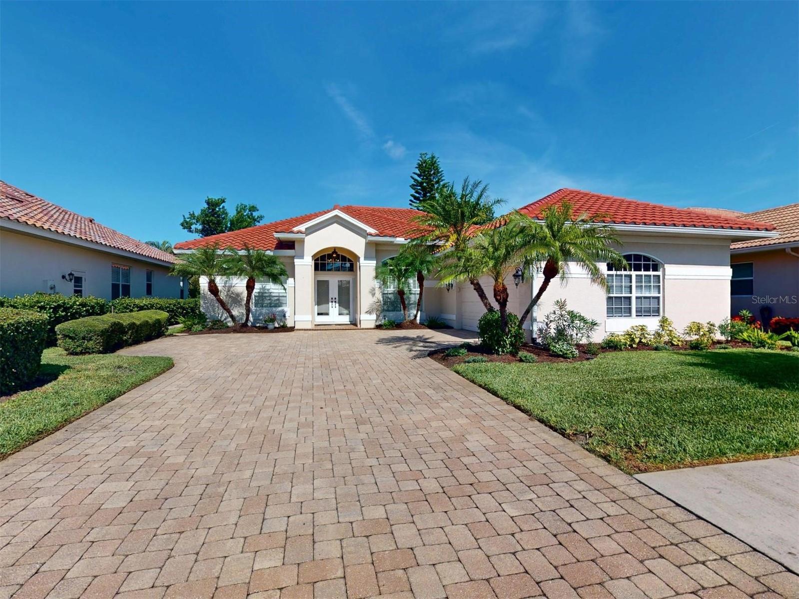 BEAUTIFULLY MAINTAINED POOL HOME IN PRESTIGIOUS SAWGRASS COMMUNITY: Experience the best of Florida living in the highly sought-after Sawgrass Golf Community with this beautifully maintained, well-appointed custom-built J&J home, ideally positioned with tranquil golf course views. This 3-bedroom, 2.5-bath pool home offers exceptional privacy, functional design, and peace of mind through extensive updates. Curb appeal stands out with a new tile roof and seamless gutters (2024), paver driveway, side entry garage door, professionally refreshed landscaping (2025), and a paver walkway leading to the pool equipment. Inside, the home features soaring 12-foot ceilings in the main living areas, crown molding, transom windows, and triple pocket sliders that invite natural light and allow for seamless indoor-outdoor living. The great room showcases elegant architectural details, perfect for both gatherings and daily enjoyment. The kitchen features Corian counters, a tiled backsplash, stainless steel appliances (refrigerator, range, microwave), a 2021 garbage disposal, ample cabinet space, a pantry closet, breakfast bar, and an eat-in nook with access to the lanai. A spacious laundry room offers cabinet storage, a utility sink, washer and dryer, and leads to an oversized 2.5-car garage measuring 581 square feet, with room for two vehicles plus additional storage. The garage also includes built-in shelving and a finished attic space, ideal for accessible extra storage. The primary suite serves as a private retreat with plantation shutters, dual custom closets including a large 5x5 walk-in, and direct lanai access. The en-suite bath includes a dual vanity, garden tub, walk-in shower, and a private toilet stall. Two guest bedrooms are connected by a Jack-and-Jill bath, while a separate half bath functions as a convenient pool bath with exterior access. The screened lanai overlooks the golf course and surrounds a free-form heated pool with a custom fountain, color-changing LED lights, and an epoxy-finished pool and lanai surface completed in 2023. Additional enhancements include a newer pool pump (2020), pool heater (2021), and rescreened lanai (2023). Mechanical improvements offer peace of mind with a newer HVAC system (2021), hybrid water heater (2023), luxury vinyl flooring in all bedrooms (2021), interior paint (2022) and all opening hurricane protection (2023) including lanai as well as front entry remote controlled automatic shutters. Radiant barrier insulation provides additional energy efficiency. Sawgrass is a premier gated community set on 54 acres of scenic lakes and preserves, with Capri's and Waterford’s golf course winding throughout (optional golf memberships are available). Amenities include a renovated clubhouse, heated community pool, fitness center, tennis courts, and four pickleball courts. Located just four miles from Venice Island’s beaches, shops, restaurants, and cultural sites, and within easy reach of grocery stores, Sarasota Memorial Hospital, and I-75, Sawgrass offers the perfect balance of convenience, privacy, and a vibrant Florida lifestyle. With low HOA fees, no CDD, and a location outside the flood zone, this home represents exceptional value in a highly desirable setting.