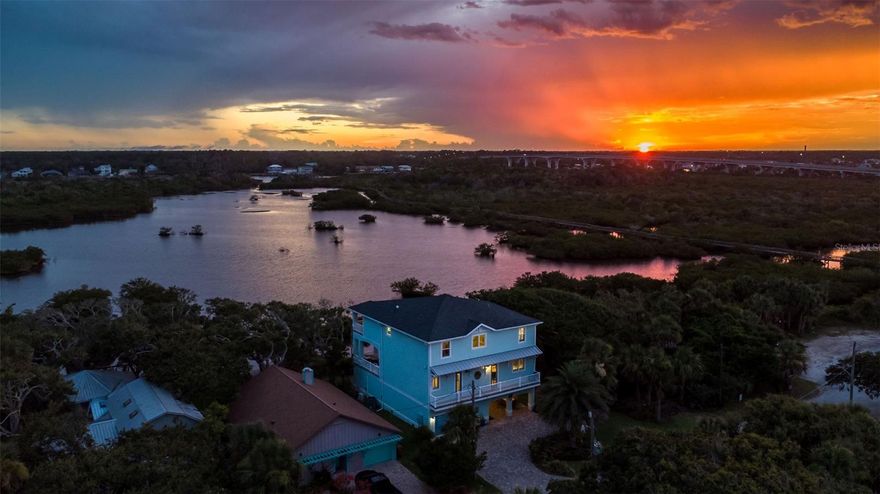 Welcome To Your Custom Built Waterfront Dream Home in desirable Flagler Beach! This stunning coastal sanctuary offers 4bedrooms 4bathrooms and sits on the Intracoastal in beautiful Flagler Beach. Enjoy panoramic water views from every room in the house, whether you are sipping your morning coffee or watching the sunset over the Intracoastal. Designed with both elegance and comfort in mind, this home offers spacious living areas, a modern open kitchen w/ island, and expansive covered outdoor spaces perfect for entertaining or relaxing. This beautiful home boasts tile plank flooring throughout main living areas, electric fireplace in living room, an elevator shaft in place/roughed in for new owner, floating dock, and an oversized 32ft deep garage. This home is perfectly located for a beautiful sunset bike ride or golf cart ride (golf cart friendly community) to and from Flagler Beach pier, local shops, beach, and restaurants. You will find yourself embracing the Florida lifestyle with boating, fishing/Kayak right in your backyard, and the beach just 3 short blocks away. Looking for activities just steps away, this home is situated next to Wickline Park where you can play tennis, pickle ball, volleyball, basketball, and offers a friendly playground for kids. Come view this one-of-a-kind coastal home today before it is gone!