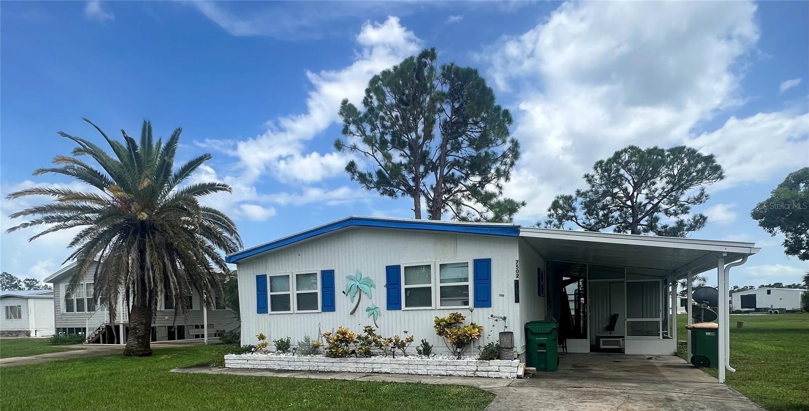 Do not miss an opportunity to own a beautiful, fully furnished 2 bedroom, 2 bathroom, totally renovated home in the highly sought-after Village of Holiday Lake. This property features beautiful open-concept living with kitchen island that can comfortably seats 8. Updates include new sub floors and laminate flooring throughout, brand new windows, new walls, hall bathroom renovation, brand new carport, newer roof and heating / cooling system, and fully screened back porch with double doors perfect for parking your golf cart. Close proximity to many beaches, shopping, and great restaurants. Community offers 25 boat slips, 2 pools, tennis courts, rec hall, shooting range, and so much more.