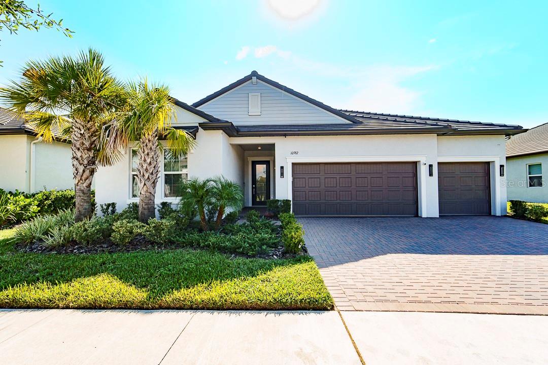 Once you walk through the door of the highest priced home in Angeline's Active +55 Community you will understand the value. This customized pool home on a premier waterfront lot has upgrades too numerous to list. Highlights include high end flooring; lighting; accent walls and built-ins; interior paint (walls, doors and ceilings); stylish doors (including glass front door and frosted French office doors); kitchen wall tile, under cabinet lighting, pull out shelving, soft close cabinet doors and drawers, quartz countertops and beverage dry bar. All bathrooms also have quartz countertops and upgraded features. There is even a towel warmer in the primary bathroom!
The three-car garage in and of itself is impressive with Polyaspartic (non epoxy) coating, a finished, walk-up attic and insulated garage doors. And the heated and cooled saltwater pool/spa with waterfall overlooking the tranquil lake and woods is breathtaking! There is also a fenced yard for additional privacy, upgraded tile and a spacious covered lanai with hurricane rated screen. The home is so amazing that you may never want to leave UNLESS you decide to walk or drive your golf cart the short distance to the stunning Clubhouse, which features a resort style pool, impressive gym, movie/event room, pickleball and shuffleboard courts, billiards room, yoga room, cafe, inside and outdoor bars and the list goes on. The monthly calendar is full of a variety of activities - from water aerobics to Mahjong.
This active, maintenance free community is on 6,200+ acres with 3,600 acres of green space, access to 100 miles of paved trails and future plans for even more grandeur. And then there's the working farm with beautiful, fresh produce, another amazing cafe and even more activities and entertainment. Angeline is the perfect community to do as much or as little as you want while enjoying the serenity of its natural beauty. And you can live in this amazing, unique home while doing so! We invite you to visit!