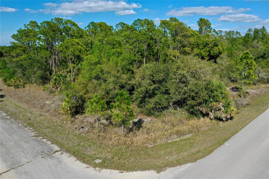 Located in the heart of North Port’s burgeoning growth corridor, this premium 0.27-acre (11,741 sqf) corner lot at the intersection of Jasper Ter and Dellbrook Ave represents a rare and versatile investment opportunity. Boasting highly coveted AC-10 (Activity Center) zoning, the property offers a flexible canvas for a visionary developer. This designation is primarily geared toward commercial and mixed-use projects, allowing for a dynamic blend of professional and residential spaces. The true potential of this site lies in its multi-story capabilities. Under current guidelines, a developer could create a three-story building featuring a commercial storefront or service-based business—such as a boutique "Dog Spa" or professional office—on the ground floor, with a modern duplex or residential units situated above. This "live-work" configuration maximizes the footprint while tapping into the high demand for integrated urban living in Southwest Florida. Development is made even more seamless as the property is notably not located in a Scrub Jay review area. While a well and septic system would be required, electricity is exceptionally convenient, with power lines already established just across the street, making the final connection to your new project straightforward and cost-effective. Strategically positioned for maximum connectivity and lifestyle, the lot is located just 5 miles from Interstate 75, offering effortless transit north toward Tampa and south toward Fort Myers. It is also just a short drive—approximately 6 miles—from US-41 and the Murdock area, home to the Port Charlotte Town Center and a wide array of dining and shopping options. Sports enthusiasts will appreciate being only 15 minutes from the Charlotte County Sports Park, the spring training home of the Tampa Bay Rays. When it's time to relax, you are perfectly situated between two of the Gulf Coast's finest destinations: the pristine shores of Englewood Beach are just 25 minutes away, while the exclusive charm of Boca Grande can be reached in approximately 40 minutes. Secure your stake in North Port's future and submit your proposal today to claim this prime corner location!