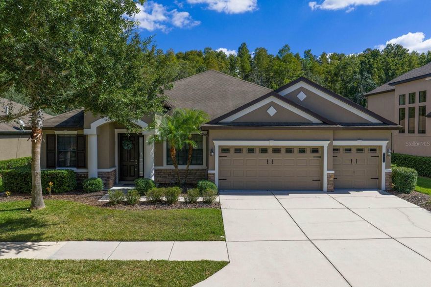 One or more photo(s) has been virtually staged. Experience the best of New Tampa living in Grand Hampton, a premier guard gated community known for its elegance and resort style amenities. This impressive 4 bedroom 4 bath residence spans over 3,000 square feet on a picturesque quarter acre conservation lot and is attractively offered to allow the next owner the opportunity to update finishes and personalize the home to their own style and décor.**

From the moment you enter, you’ll be greeted by elegant architectural details, crown molding, and an abundance of natural light that enhances the home’s open and welcoming layout. The formal living area transitions effortlessly into the heart of the home, a stunning chef’s kitchen showcasing solid wood cabinetry, granite countertops, stainless steel appliances, recessed lighting, and a charming built in breakfast nook with bench seating.

A private guest suite and full bath are conveniently located near the entry, while two additional secondary bedrooms provide ample comfort and flexibility, one featuring its own en suite bath and walk in closet. The primary suite is thoughtfully positioned at the rear of the home, overlooking the peaceful conservation area. Here, tray ceilings, a spa inspired bathroom with dual vanities, soaking tub, walk in shower, and generous walk in closet create a true retreat. Upstairs, a spacious loft with its own closet offers flexibility for a home theater, gym, office, or even a fifth bedroom if desired.

Outside, French doors lead to a screened in lanai finished with porcelain wood look tile, perfect for relaxing or entertaining while enjoying the tranquil wooded backdrop and complete privacy with no rear neighbors. Recent updates include a new AC unit in 2021 and a tankless water heater in 2022. The oversized 3 car garage provides plenty of room for storage or hobbies.

Residents of Grand Hampton enjoy resort style living with world class amenities including a 24 hour manned gate, clubhouse, fitness center, playgrounds, multiple heated pools with a water slide, spa, tennis and basketball courts, and scenic lake access.

This home presents an exceptional opportunity to create your dream space in one of Tampa’s most sought after master planned communities. Ideally located near I 75, I 275, AdventHealth, The Shops at Wiregrass, and Tampa Premium Outlets, and just a short drive to the Gulf beaches, the vibrant lifestyle of downtown Tampa, and top rated New Tampa schools, this is Florida living at its finest. Welcome Home!