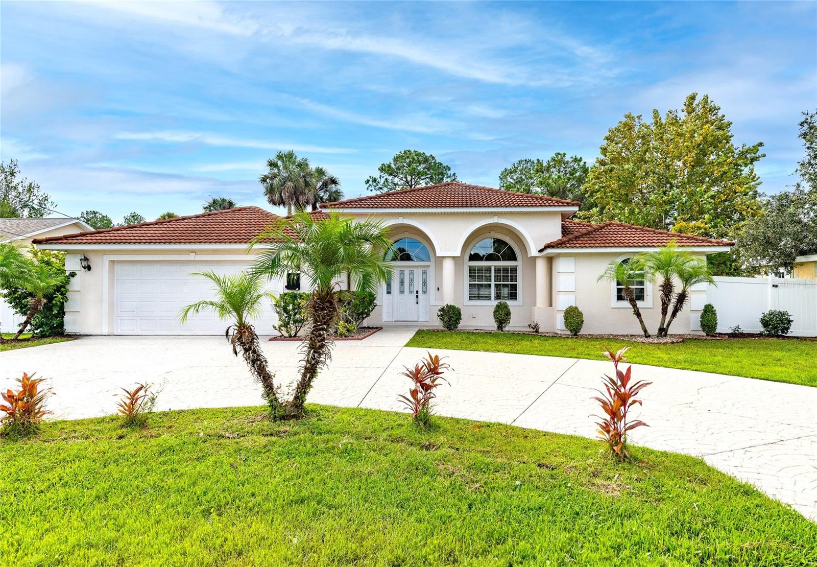 Recent upgrades and renovations set this gorgeous pool home apart! Can you say spacious? At over 2400 sq feet under air this home is perfect for entertaining or a growing family. With the kitchen being the focal point of the home, there is a family room and living room on either side with all 3 living areas overlooking the beautiful pool with its large covered lanai. The kitchen has a breakfast bar, new granite countertops, stainless appliances, custom cabinetry and a newly upgraded farmhouse style sink, plumbing and light fixtures. There is an informal dining in the kitchen area as well. The pool and lanai can be accessed from the living room, family room, primary bedroom or from the hall where the guest bedrooms are located. This is a split plan with the 3 guest bedrooms and 2 full guest baths on one side and the private primary bedroom on the opposite side featuring 2 walk in closets, an ensuite bath with 2 vanities, garden tub and custom tiled ease of entry shower enclosure. The pool area is a whole other living space in this home. With its screened enclosure and 440 sq feet covered lanai this is the perfect place to relax or to entertain family and friends. The pool has a jacuzzi spa that flows into the pool and there are doors on either side of the enclosure to access the back and side yards which are perfect for the pups or kids. There is also a detached storage building in the side yard as well. Some of the recent upgrades include an electric vehicle (EV) outlet in the garage, as well as a generator hookup. The oversized 650 sq ft garage has lots of storage cabinets and counter space for your tools. The kitchen has quartz countertops, custom cabinetry and SS appliances new in 2024 and 2025. Other upgrades include a new water heater 2025, Irrigation equip 2025, light fixtures 2024 and laminate flooring in guest bedroom 2024. The AC has been recently serviced as has the pool equipment. The pool enclosure completely rescreened in 2025. New attic insulation in 2025 and there is a wall safe in one of the guest bedrooms. This home sits on an oversized 1/3 acre corner lot and is very private with its fenced backyard and vacant lot behind the home. This central location is perfect with its close proximity to shopping and restaurants and short drives to the gorgeous Flagler beaches and Historic St Augustine.