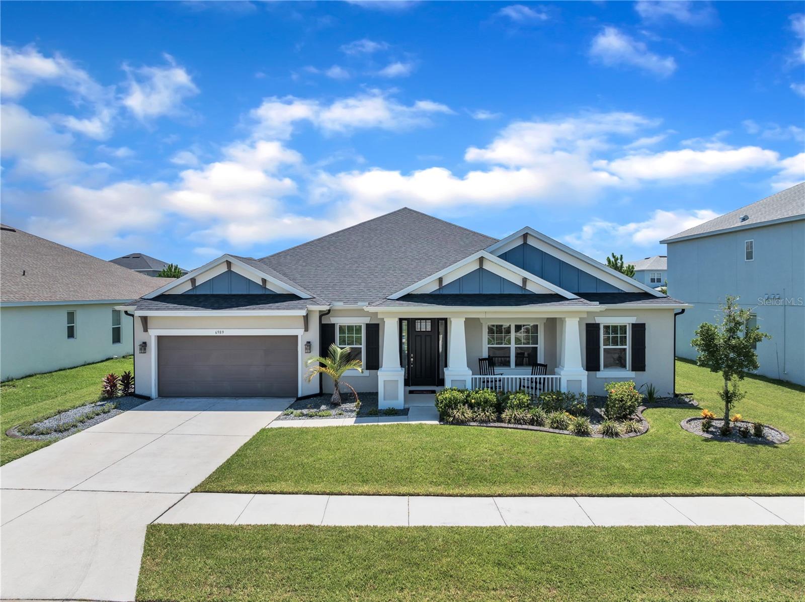 This residence is located on a premium lot within the gated community of Bradbury in Watergrass. The home includes 4 bedrooms plus a flex space, 3.5 bathrooms, and a 3-car garage, covering 3,221 sq ft of living area. Features include engineered hardwood floors, ten-foot ceilings with custom tray wood accents, crown molding, and 5¼" baseboards throughout. The formal dining area includes tray ceilings with wooden accents and is adjacent to a coffee bar with a wine fridge. A flex room offers potential use as a home office, game room, or library.
The main living area contains a glass fireplace, integrated surround sound, wood-beamed tray ceilings, and views of the backyard through 9' pocket sliding doors. The layout supports indoor-outdoor connectivity for gatherings or quiet enjoyment of the yard.
The kitchen is equipped with quartz countertops, soft-close solid wood cabinetry, LG ThinQ stainless appliances, a glazed backsplash, and a coffee and wine bar with LED lighting and a wine fridge. There is an oversized pantry and additional prep space nearby.
The outdoor area features a heated saltwater pool and spa with sun shelf jets, color-changing lights, fountains, and a screen enclosure. Amenities include an outdoor kitchen, dry bar, bar fridge, gas grill, travertine decking, dual lounge areas, and an outdoor sound system. The yard is enclosed with PVC fencing and green space.
The primary suite has three large windows, double tray ceilings, crown details, and a 20’ x 14’ bedroom space. Walk-in closets with built-ins connect to the ensuite bathroom, which includes split vanities, quartz countertops, a soaking tub, and a tiled glass shower.
Three additional bedrooms are included, two of which share a Jack-and-Jill bathroom. The fourth bedroom and the Media Room share a full bathroom with a glass shower. The Media Room features surround sound and an electric fireplace. Additional functional areas include a dedicated laundry room with cabinetry and a 3-car garage with an EV charger.
Additional highlights include: A Whole-home interior and exterior Sonance by Sonos audio system, Water softener system, Irrigation and French drain systems, Terminix bait perimeter protection, Smart-controlled lighting and fireplaces in the living room and Theatre rooms, 24" porcelain tile in wet areas.
Watergrass is more than a neighborhood; it’s a lifestyle. Enjoy access to resort-style amenities including parks, fitness center, pools, basketball/tennis courts, and new Publix and Starbucks minutes away. With fast access to major highways, you’re connected to the best of Wesley Chapel and beyond.