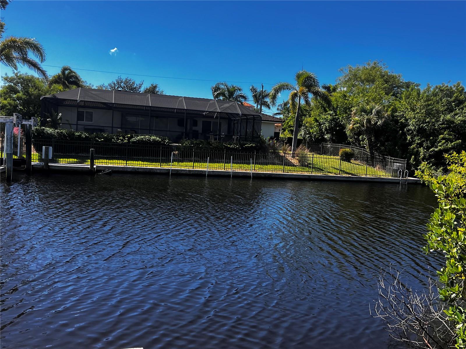 BEST PRICED LOT IN PIRATE HARBOR! Motivated Seller, bring an offer! Don't miss out on this Waterfront lot with 100 feet on the water and mangroves at waters edge. Catch a Snook or Tarpon right in your backyard or watch the dolphin & manatee swim by. This land offers Southern rear exposure with 100 ft of canal front. Land is ready for your custom dream pool home. Pirate Harbor is a one-of-a-kind waterfront community in Charlotte County with NO Bridges or locks to inner coastal water + direct access to the Gulf of Mexico. This lot is .25 acres, and dimensions are 100' x 110' x 100' x 110'. Located on a street with other new custom homes, this community is sure to impress. One-of-a-kind location featuring some of the best fishing & boating in Southwest Florida. Jump in your boat & head to the Boca Grande pass, Cabbage Key, Pine Island or any of the other barrier islands surrounding. Community offers water & sewer hookups, NO deed restrictions, a voluntary HOA & is a Golf Cart approved community. Pirate Harbor is centrally located between Sarasota and Naples with convenient access to schools, hospitals, hotels, shopping, restaurants, Sunseekers Resort, Farmers Markets, & more. Safe Harbor Burnt Store Marina is located only minutes away offering a Full-Service Marina, Golfing, Dining, a Fitness Club & more. Just under one hour to Southwest Florida International Airport and beaches. The Punta Gorda airport is only 20 minutes away. Don't miss your chance to own a piece of property in Punta Gordas most desirable fishing community. Call today to make this property yours!
