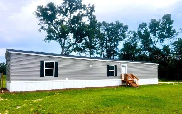 BRAND NEW 3BD 2BA SWMH on a gorgeous 1.27 ACRE property in GIlchrist County, between Bell and Branford, FL! This new setup is move-in ready! Comes with dishwasher, range, refrigerator AND washer & dryer! The open floor plan helps the home feel spacious and the split floor plan allows for sleeping privacy on each end of the home. A utility room is right off the kitchen for convenience and will also allow for some storage. Vinyl flooring throughout allows for easy clean up and durability. Upgraded doors, recessed lighting, and underground power are just a few more added perks to this property. Situated less than half a mile off TWO paved roads on a lusciously green oversized lot, this property is perfect for those seeking affordable housing! Exactly 9 miles from both Bell and Branford, you can have access to numerous shopping, dining, and medical options. 2 miles from the Santa Fe River and Sandy Point Public Boat Ramp, this location is perfect for all river-goers, including boaters, swimmers, and kayakers. Head down river just a few miles where you will meet the confluence with the Suwannee River and can explore even further. What an awesome location! You have the best of both worlds! Several freshwater springs just down river on the Suwannee or upriver on the Santa Fe. Within a 30 minute drive to Lake City or Alachua and 20 minutes to High Springs or travel less than an hour to Gainesville for more employment, medical, and education opportunities. Gilchrist County offers low property taxes and "A" rated schools. This property will not last long! Call today!