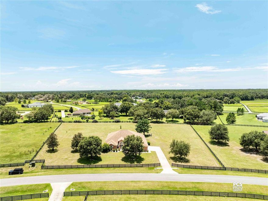 Nestled on a serene 2.55-acre lot within the gated enclave of Sumter Crossing, this 4-bedroom, 2½-bath home seamlessly combines elegance with the tranquility of spacious country living. As you pass through the private gated entrance, you’ll immediately feel the upscale ambiance and peaceful charm of the neighborhood. Inside, the home features an open-concept layout with soaring ceilings, expansive windows, and durable tile flooring, creating a bright and inviting flow between the living, dining, and kitchen areas—ideal for both relaxing and entertaining.The chef’s kitchen is a highlight, offering abundant storage with custom cabinetry, sleek granite countertops, and high-end stainless steel appliances, including a double oven—perfect for preparing meals, whether for intimate gatherings or large family celebrations.The primary ensuite is a true retreat, featuring a sliding glass door that opens directly to the back patio, offering seamless access to outdoor living. The luxurious bathroom is designed with dual vanities, a beautifully tiled shower, and a soothing soaker tub, transforming the space into a spa-like sanctuary. A spacious walk-in closet ensures ample storage for all your wardrobe essentials.Each of the four generously sized bedrooms provides comfort and privacy, while the 2½ baths combine style and practicality. Outside, the fully fenced yard offers both privacy and security, creating a perfect setting for pets, children, or peaceful relaxation. The two-car garage provides plenty of parking, while the additional golf cart garage offers extra space for storage or recreational vehicles.