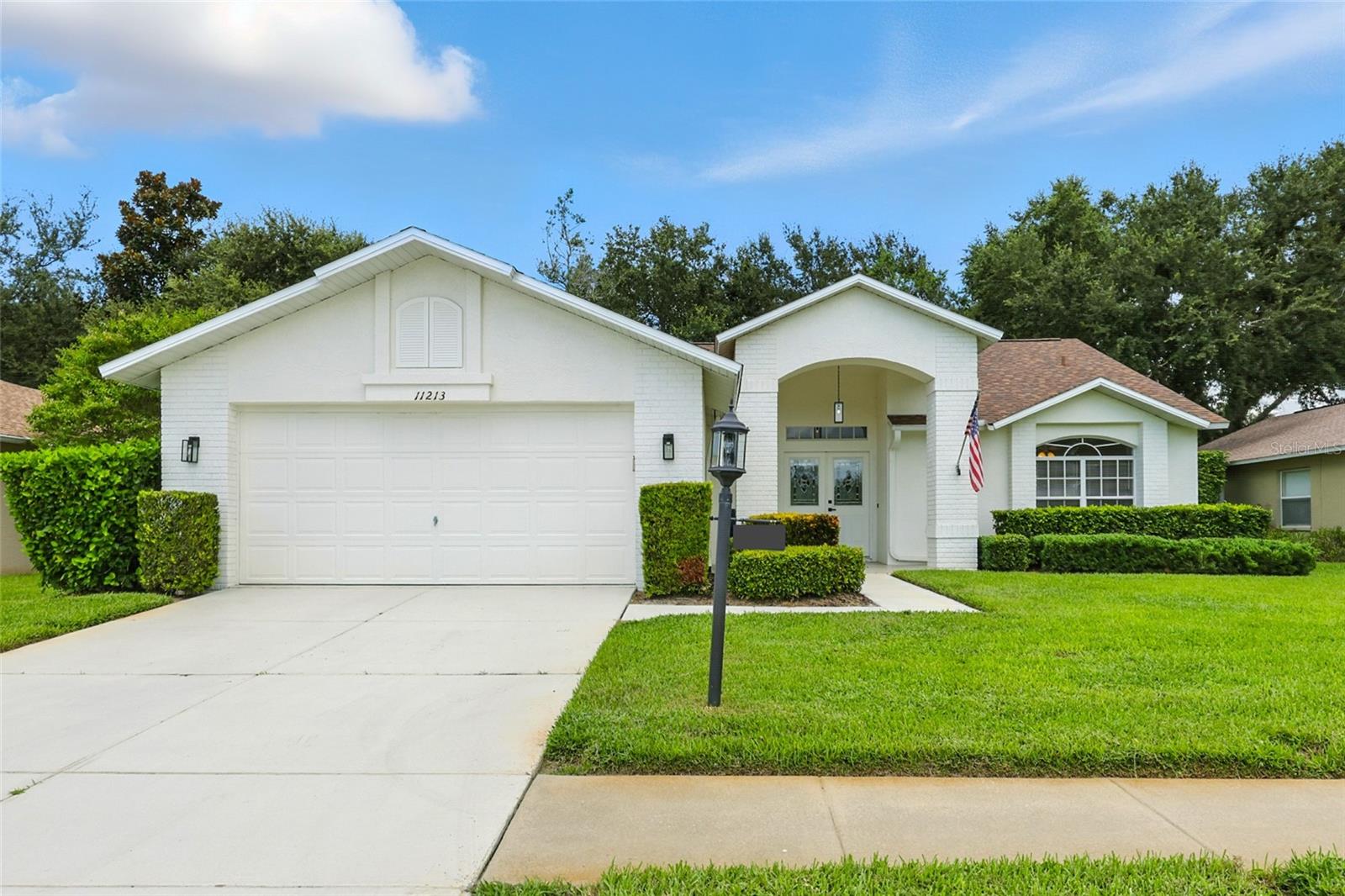 Welcome to your newly remodeled home in the highly desirable, gated golf community of Heritage Pines. This beautifully updated 3-bedroom, 2-bath residence offers 1,834 square feet of stylish living space. A freshly epoxied entryway leads to elegant double doors, opening into a bright and spacious interior with soaring cathedral ceilings, modern fixtures, and luxury vinyl plank waterproof flooring throughout. The heart of the home is the stunning new kitchen, featuring custom cabinetry, quartz countertops, a modern backsplash, stainless steel appliances, a large island, closet pantry, and a sunny dinette area—all flowing seamlessly into the open dining and living room. The primary suite boasts dual walk-in closets, sliding glass doors to the lanai, and direct access to a completely remodeled Jack-and-Jill bathroom with quartz-topped dual sink vanity, modern fixtures, and a new walk-in shower. This bathroom also connects to the versatile front bedroom, perfect as an office or guest space. On the opposite side of the home, you’ll find the third bedroom and an updated second bathroom. Additional highlights include a large indoor laundry room, a 2-car garage with freshly epoxied floors, and multiple access points leading to the covered and screened lanai. This move-in ready home offers peace of mind with a brand-new roof, a 2025 water heater, and a 2016 AC system. Heritage Pines residents enjoy resort-style living with an 18-hole championship golf course, clubhouse with restaurant and bar, heated pool and spa, fitness center, tennis, pickleball, bocce, and more. HOA fees cover cable, internet, lawn care, and irrigation, ensuring a low-maintenance lifestyle. Don’t miss your chance to own this beautiful home—be sure to view the 3D virtual tour and schedule your private showing today!