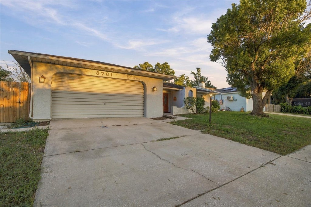 Photo of 8731 Woodcrest Drive, Port Richey, FL 34668 (MLS # TB8561309)