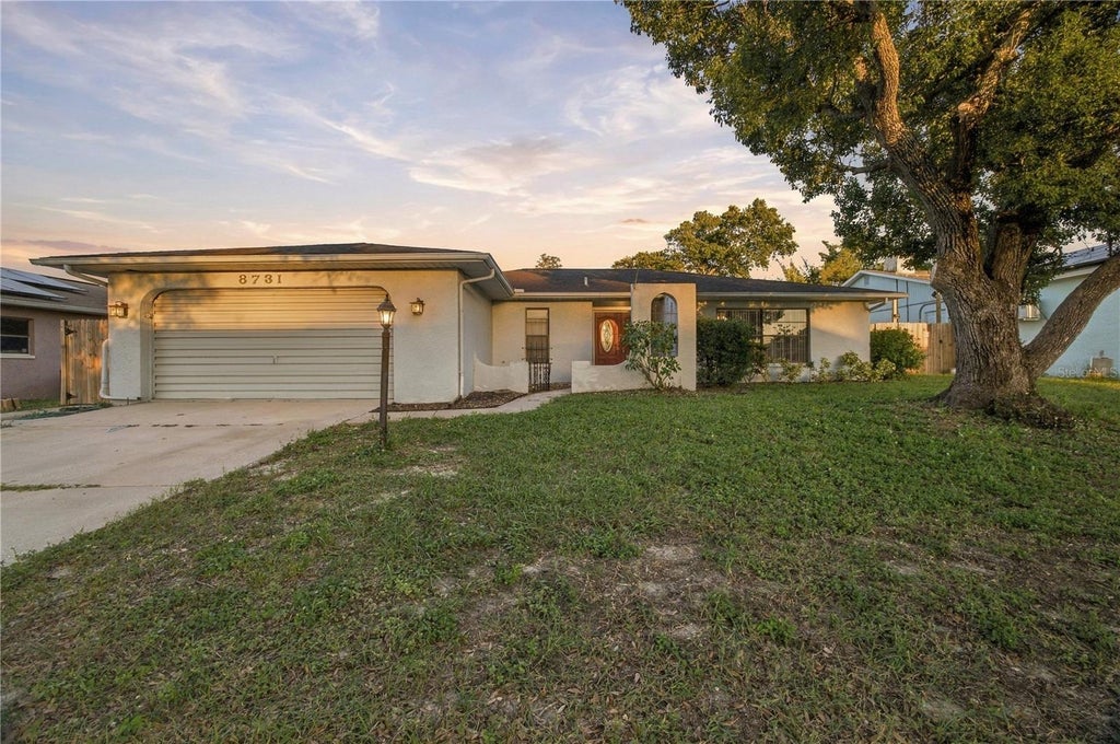 Photo of 8731 Woodcrest Drive, Port Richey, FL 34668 (MLS # TB8561309)