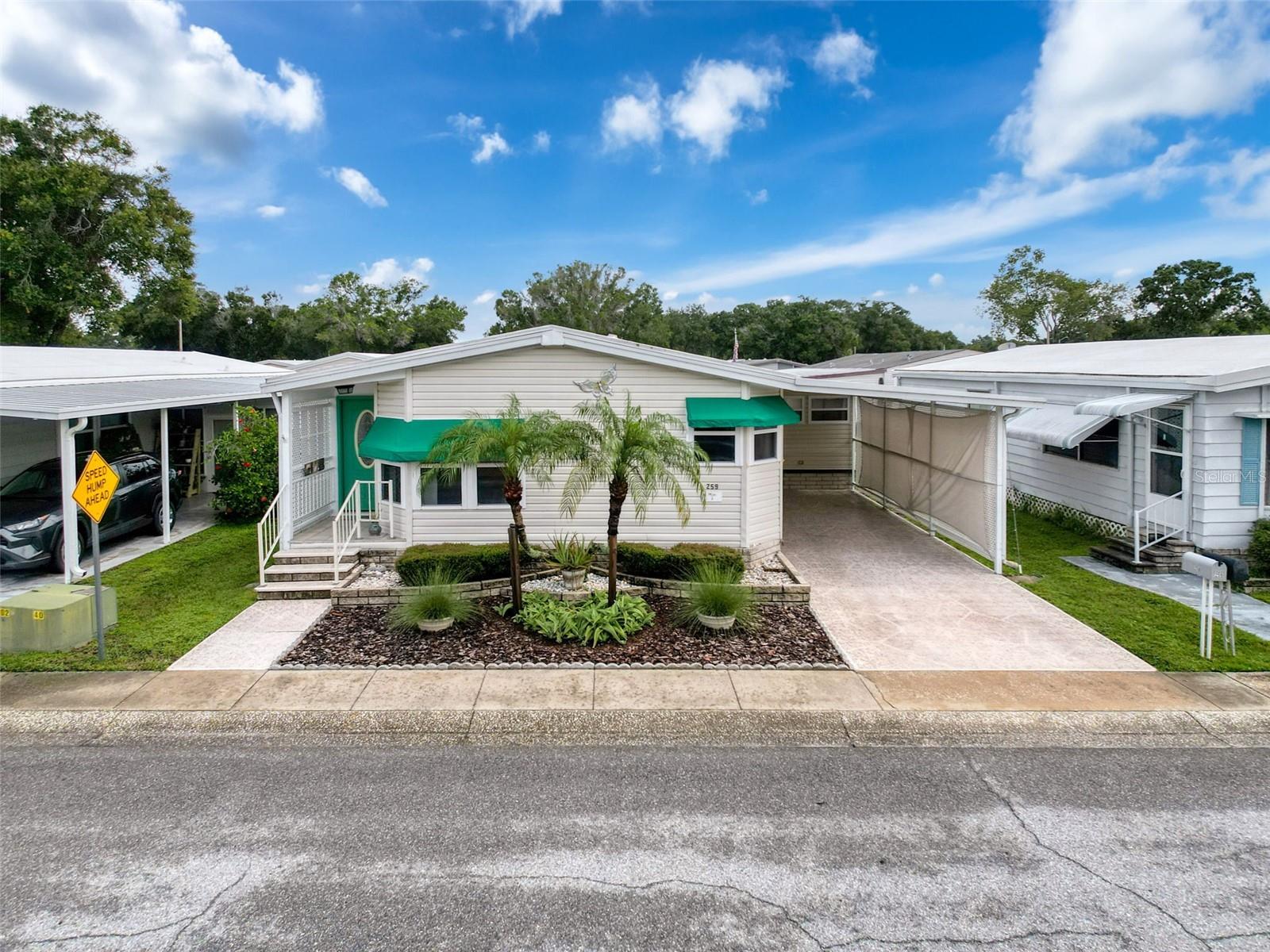 Welcome to this unique and meticulously updated mobile home that redefines comfort and style! Boasting nearly 1,500 SF of thoughtfully designed space, this home is a gem with its soaring vaulted ceilings that create an open and airy feel while providing lots of natural light. Gorgeous updates throughout, the home features an inviting wrap-around kitchen with newer appliances, a spacious living area that flows effortlessly, an expansive primary suite complete with a generous walk-in closet, and an inviting Florida room with AC that is perfect for relaxing. Enjoy the convenience of an indoor utility room as well as an extra storage room currently used as a woodshop.  This home has been well maintained with more upgrades that include AC (2022) with annual servicing, water heater (2022), roof (2016), newer tie downs, updated vinyl windows, and newer tie downs on the carport. Paradise Island Coop is a highly sought after community in a prime location with great amenities and low HOA fees. HOME IS IN FLOOD ZONE X AND RECEIVED NO DAMAGE IN 2024 STORMS! **With proper documentation, service/emotional support animals could be accepted--see park management for approvals** Schedule your showing today!
